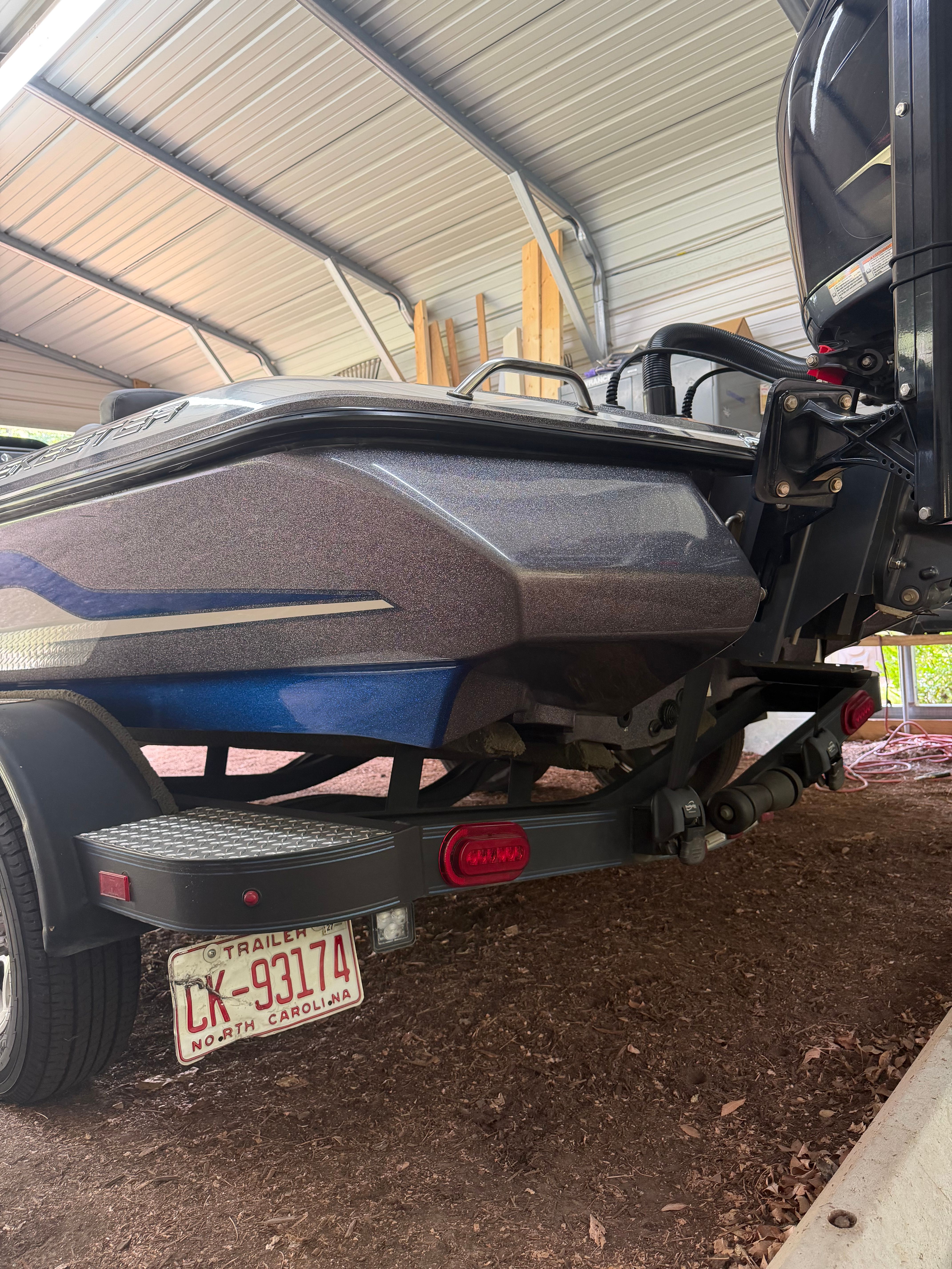 A 2017 Skeeter ZX250 boat is on a trailer in a covered area.