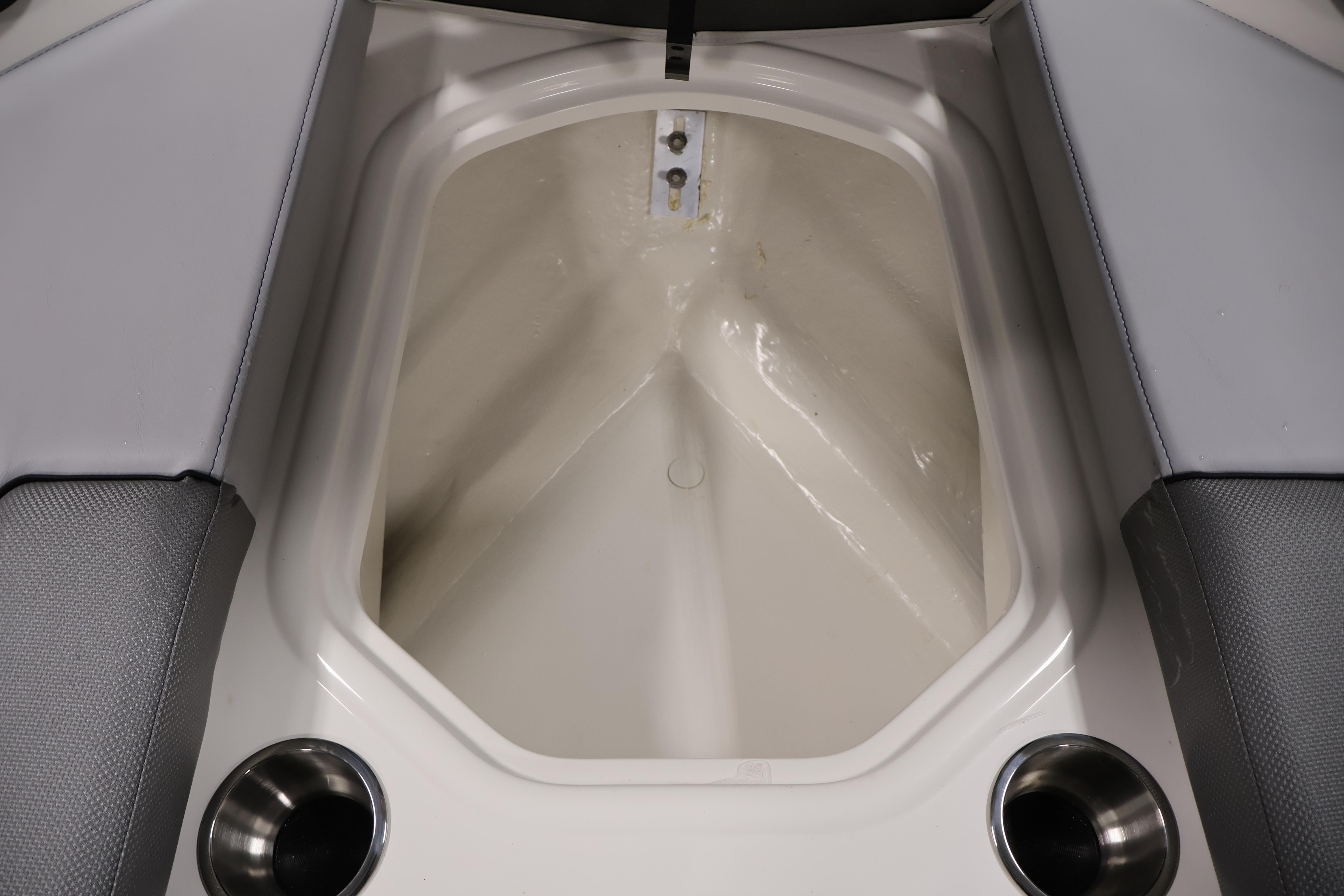 2026 Bayliner VR6 Bowrider I/O interior storage compartment with cup holders.