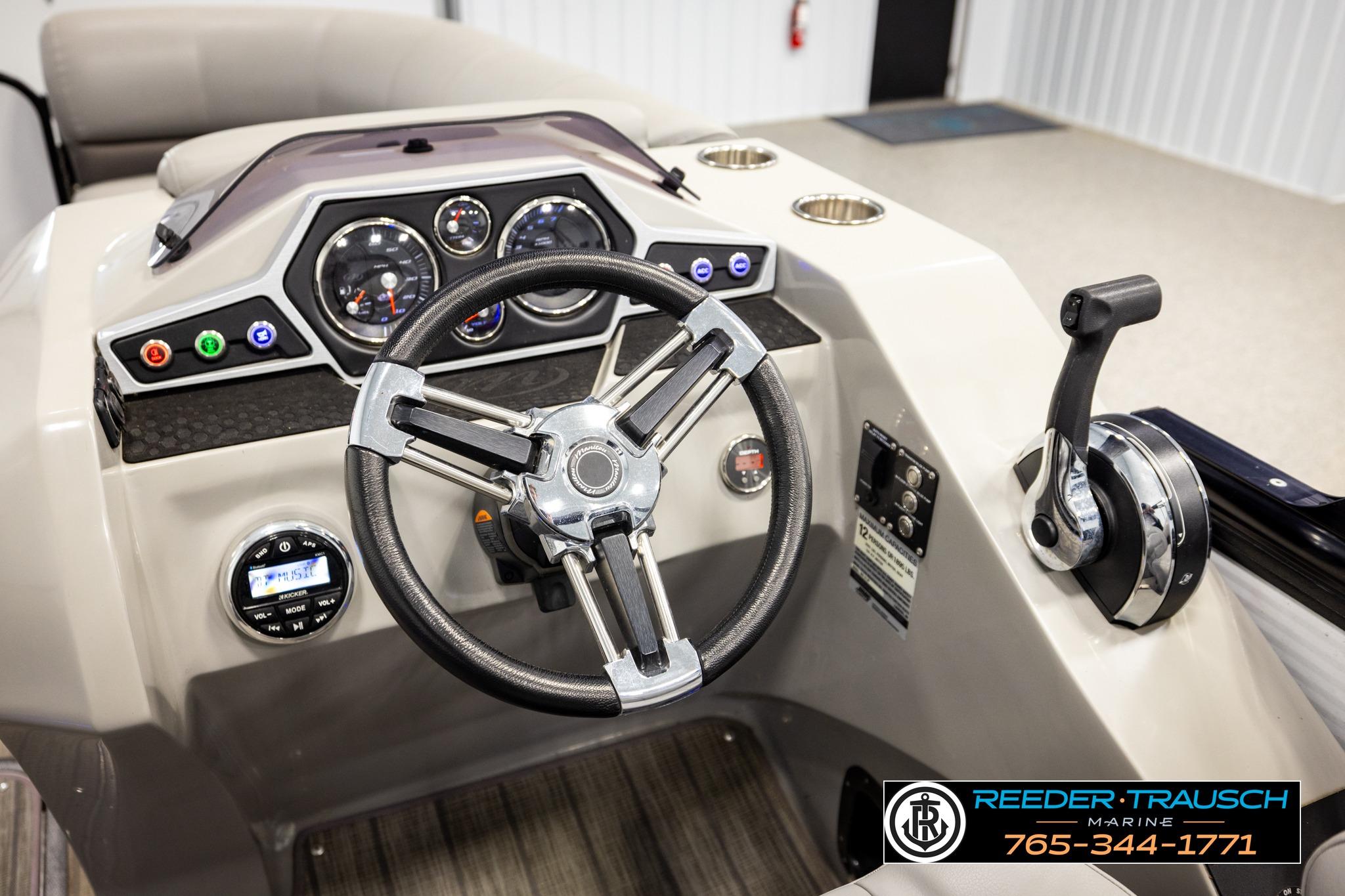 2019 Manitou Oasis SR VP boat dashboard with steering wheel and control panel.