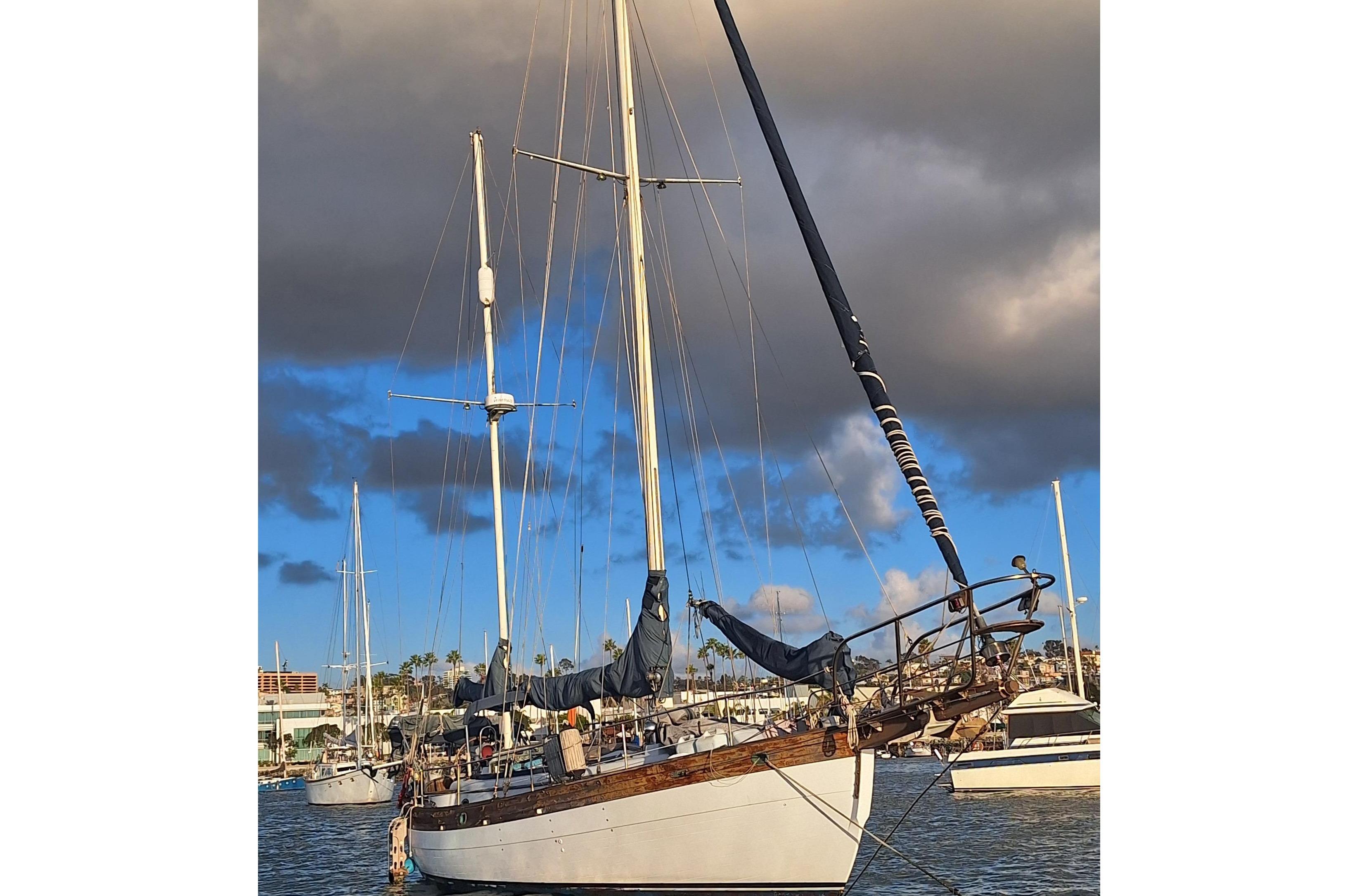 1977 Hans Christian 38 sailboat docked under cloudy sky.