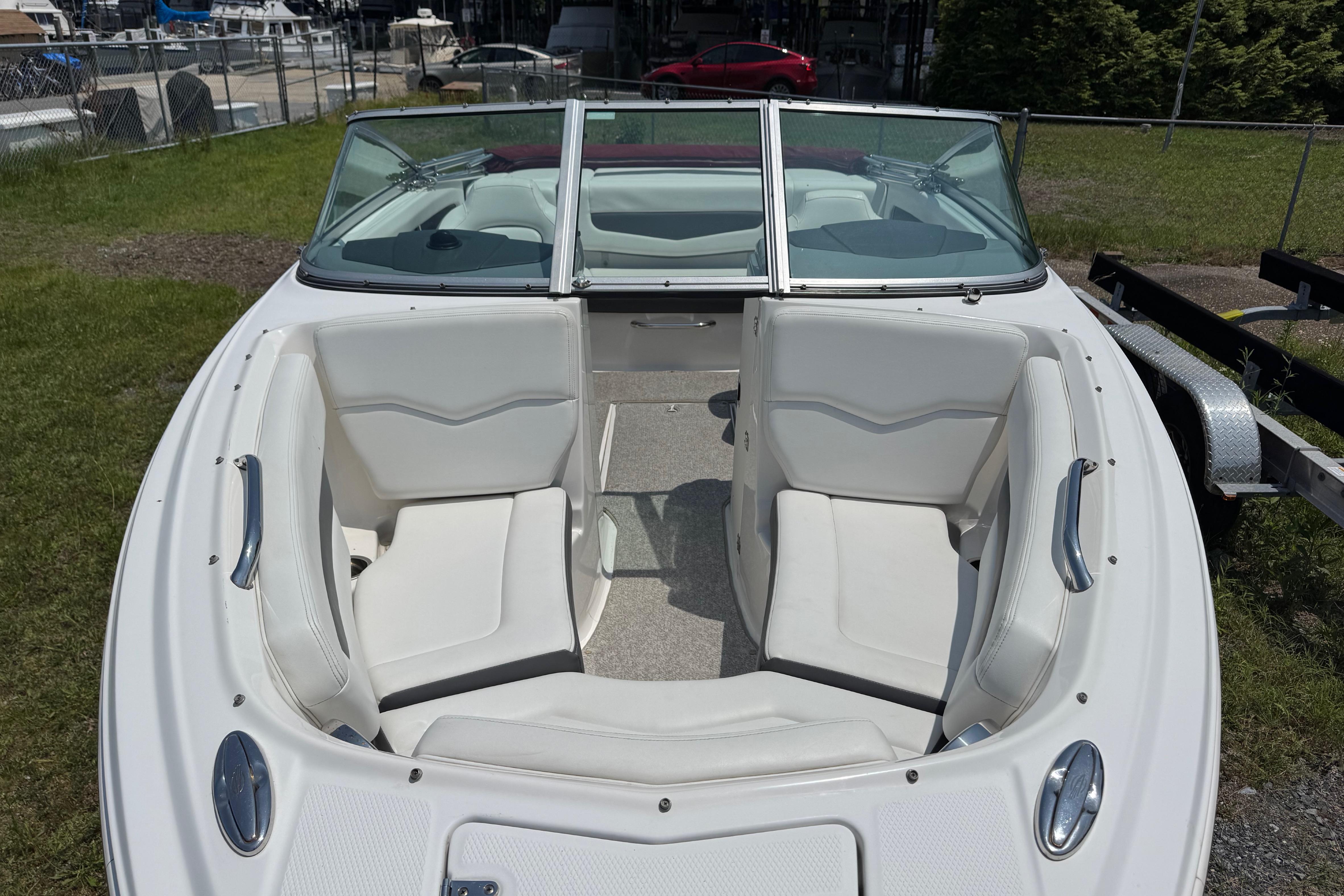 2013 Chaparral 196 SSi boat with white seating and open bow design.
