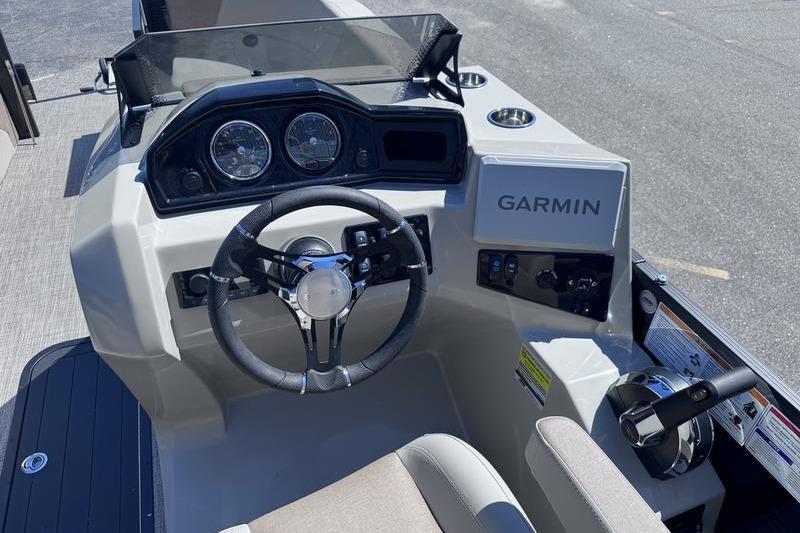 Cockpit of 2027 Manitou Aurora 23 RF SHP boat with Garmin navigation system.