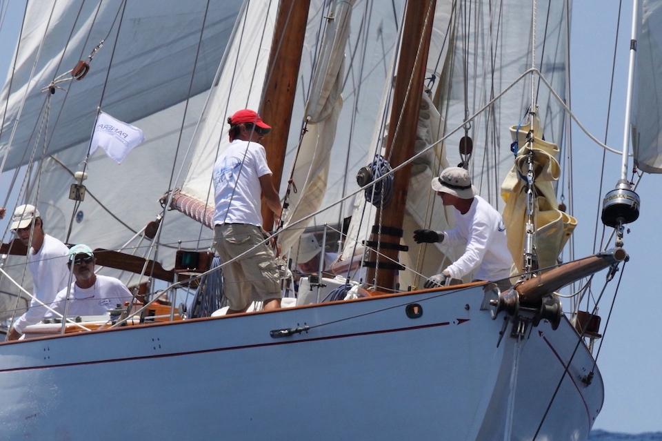 Sailors on 1928 John G Alden No. 215 yacht navigating at sea.