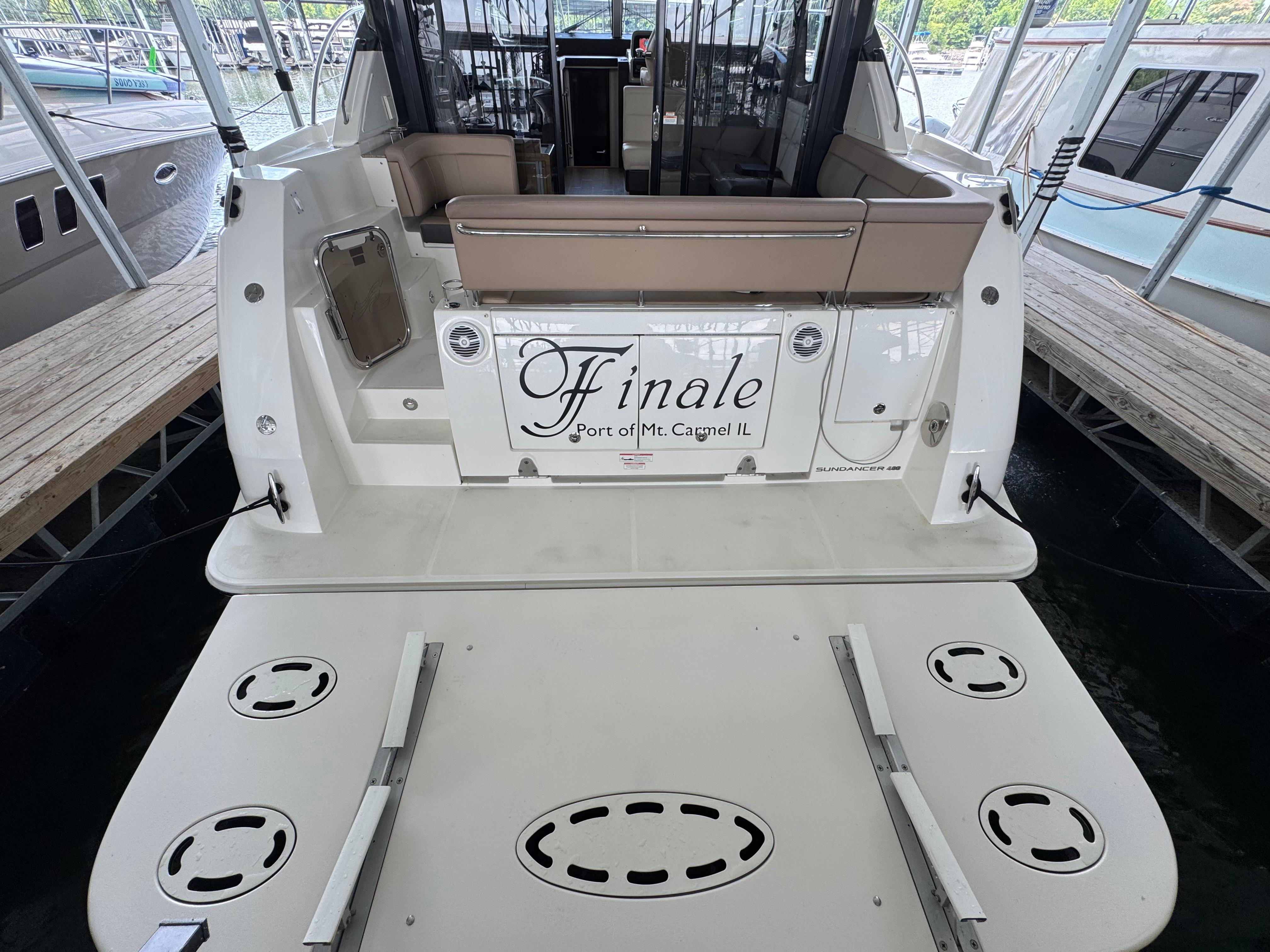 2017 Sea Ray Sundancer 400 yacht docked, rear view with seating and "Finale" nameplate.