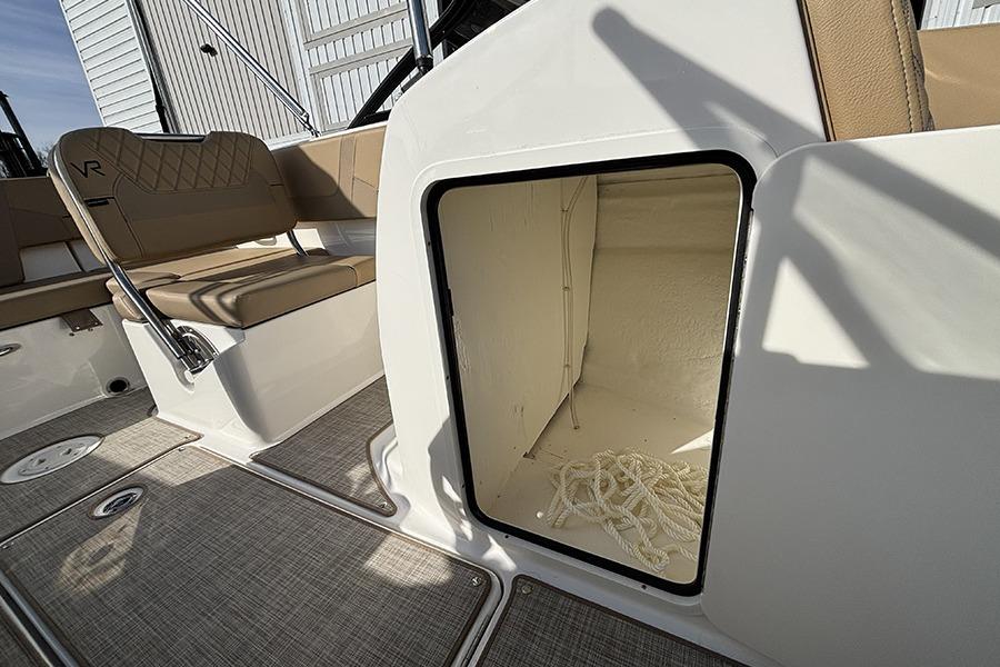 2023 Bayliner VR5 Bowrider OB interior storage compartment with rope, beige seating.