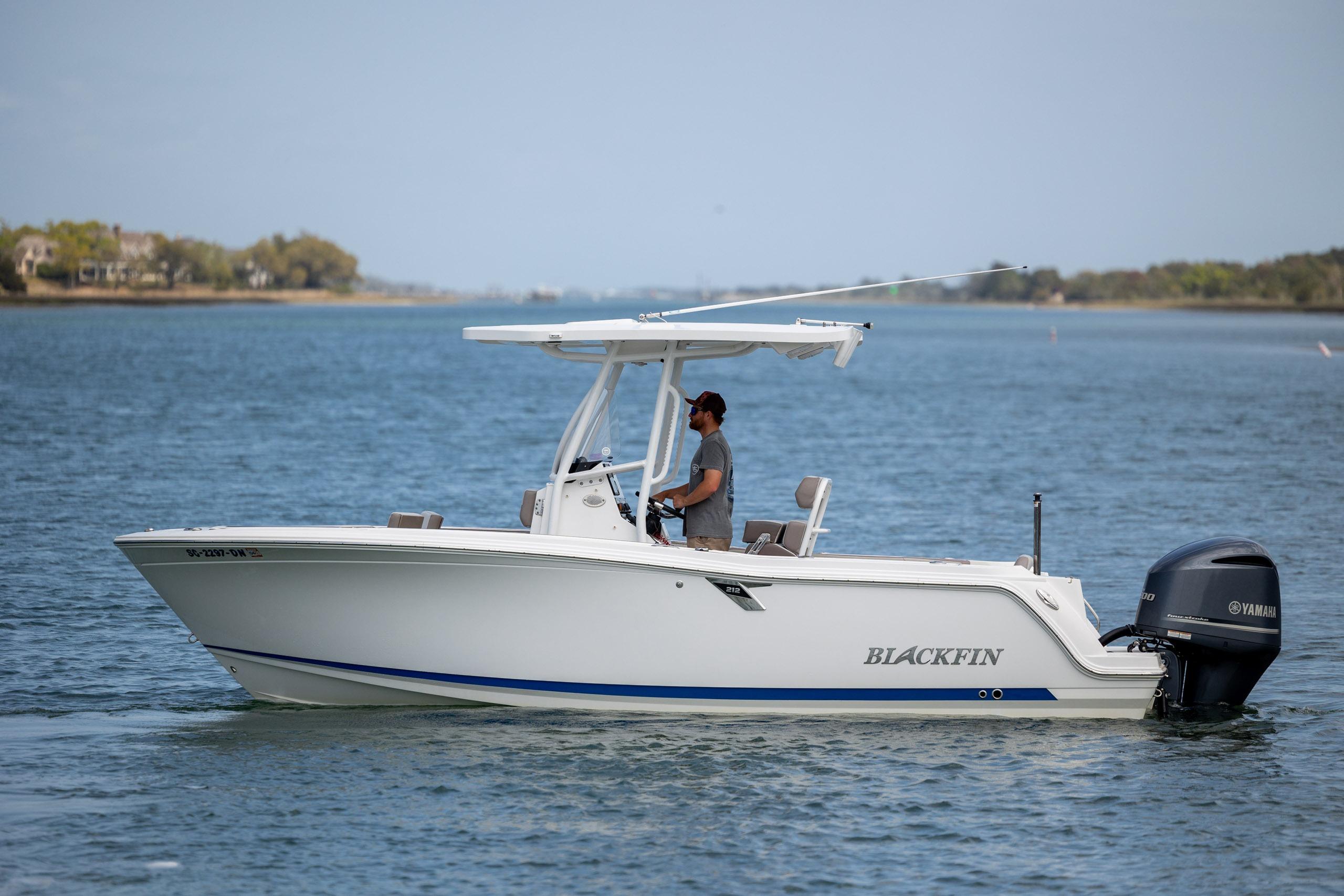 2019 Blackfin 212 CC boat cruising on a calm lake with a Yamaha engine.