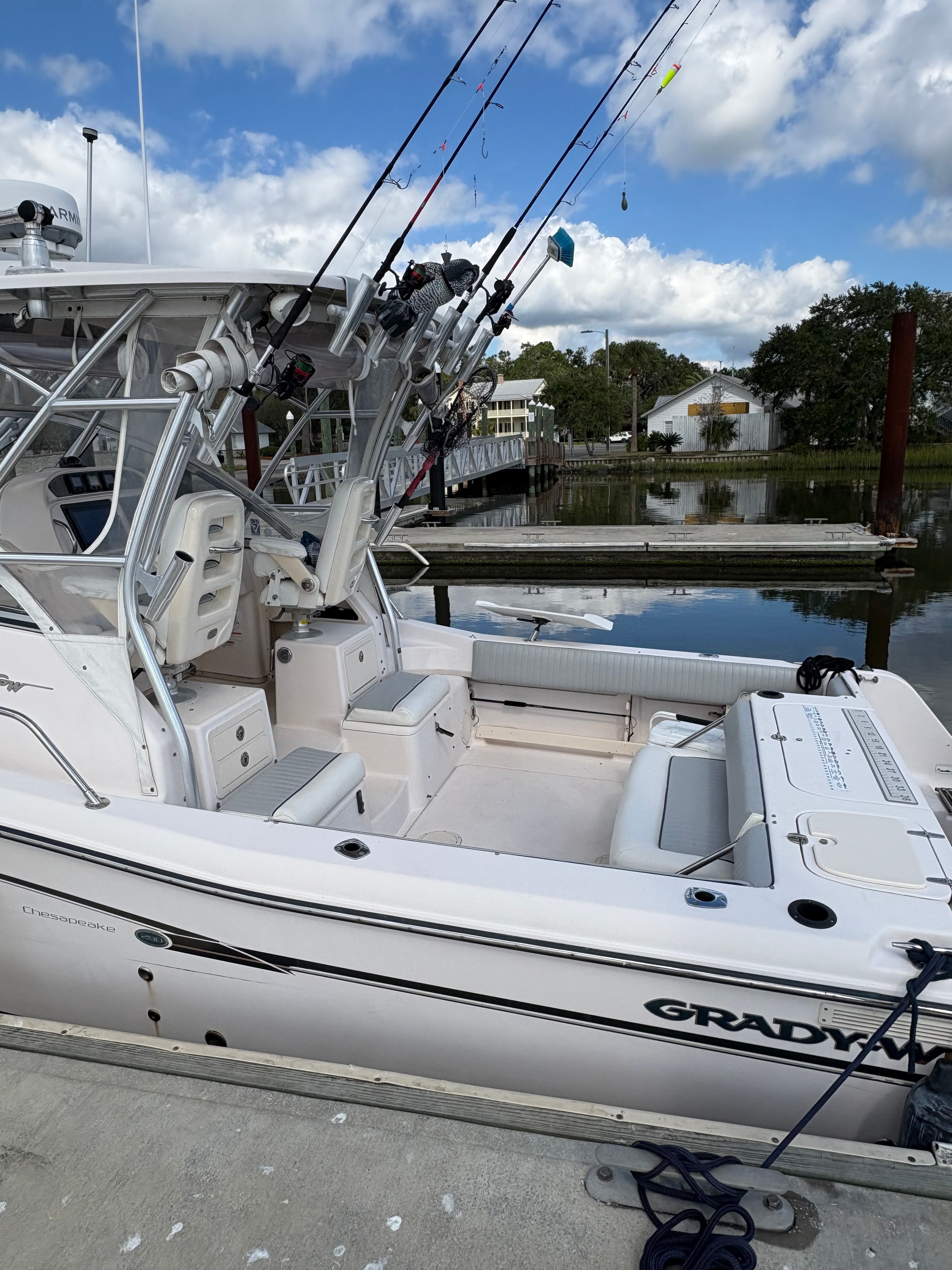 2009 Grady-White Chesapeake 290 boat docked with fishing rods.