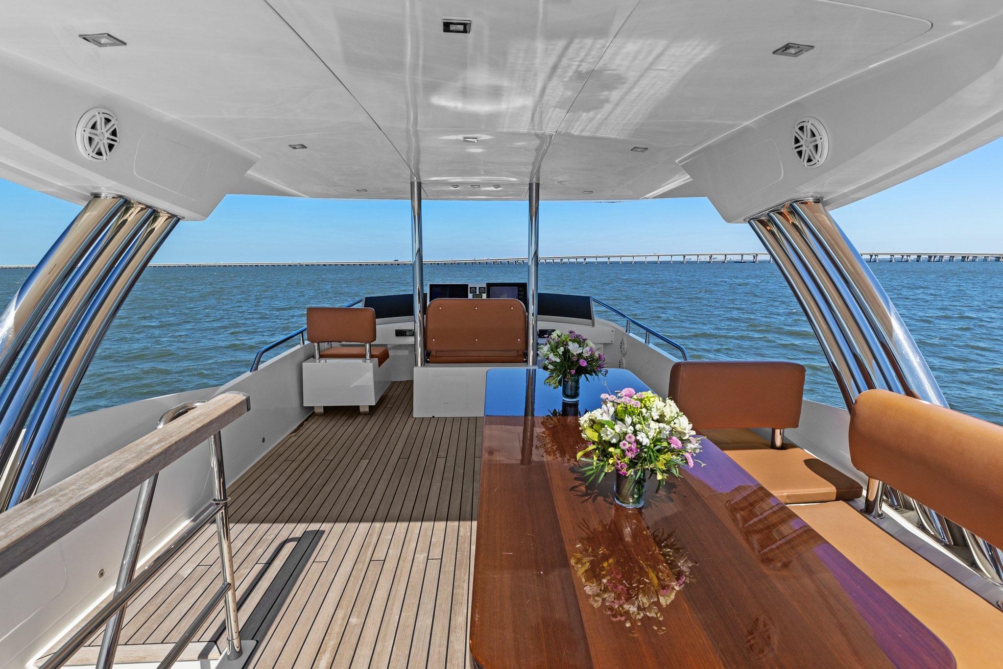 Luxurious 2013 Cheoy Lee 76 Alpha yacht deck with elegant seating and ocean view.