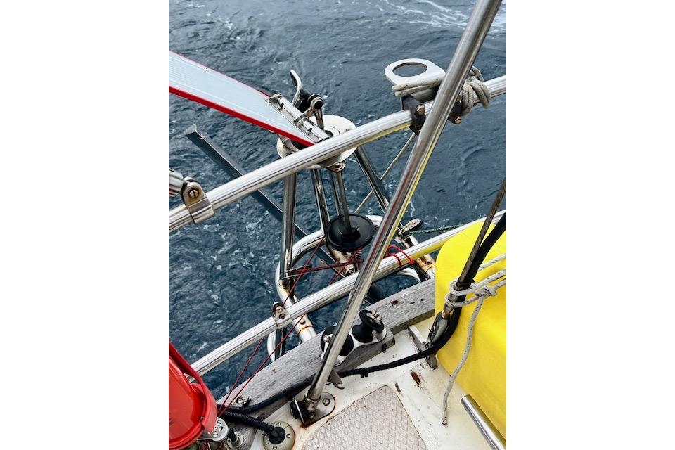Close-up of 1985 Robert Clark Ketch sailboat deck with rigging and ocean view.