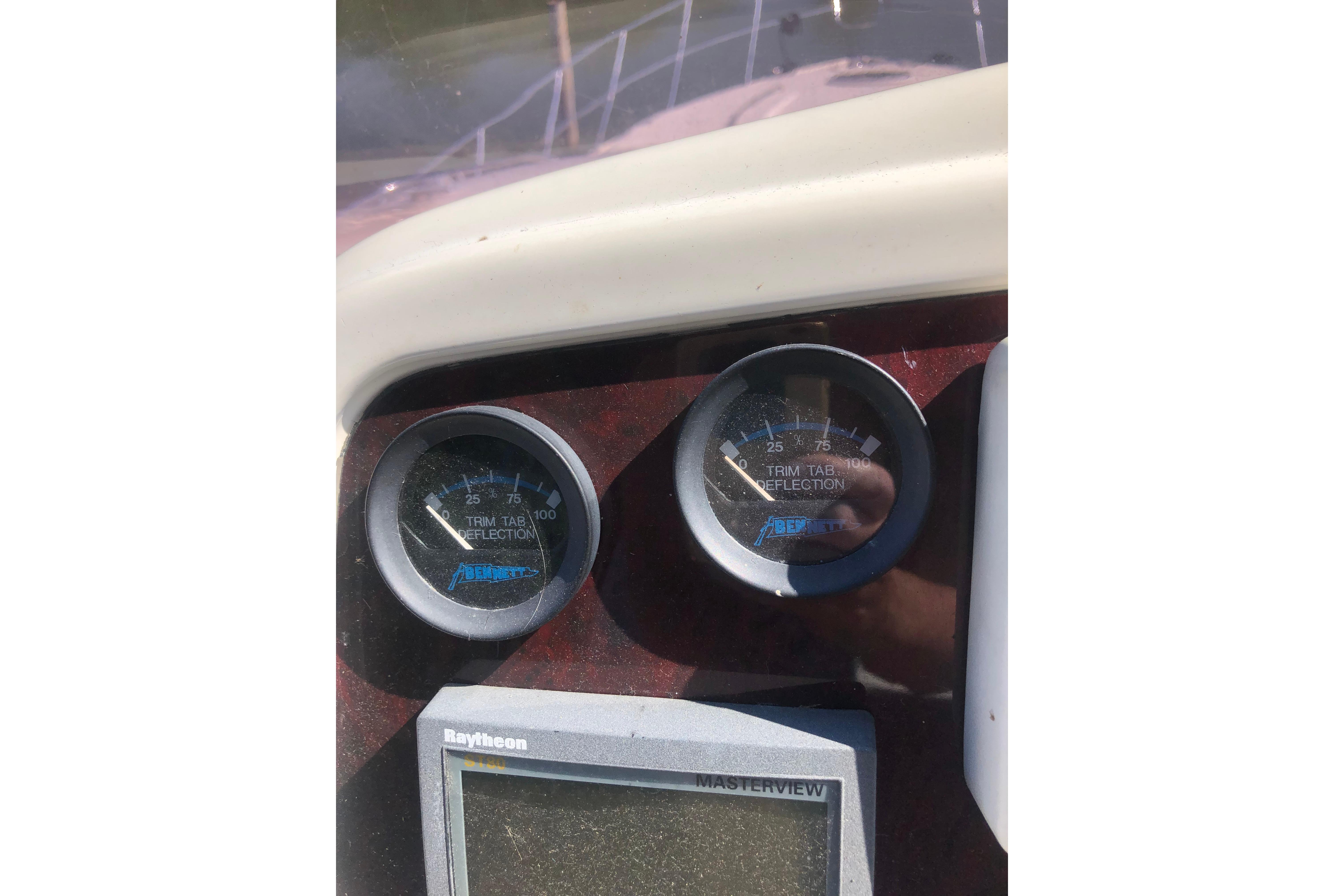 Close-up of 2002 Birchwood Challenger 460 Flybridge dashboard gauges and Raytheon display.
