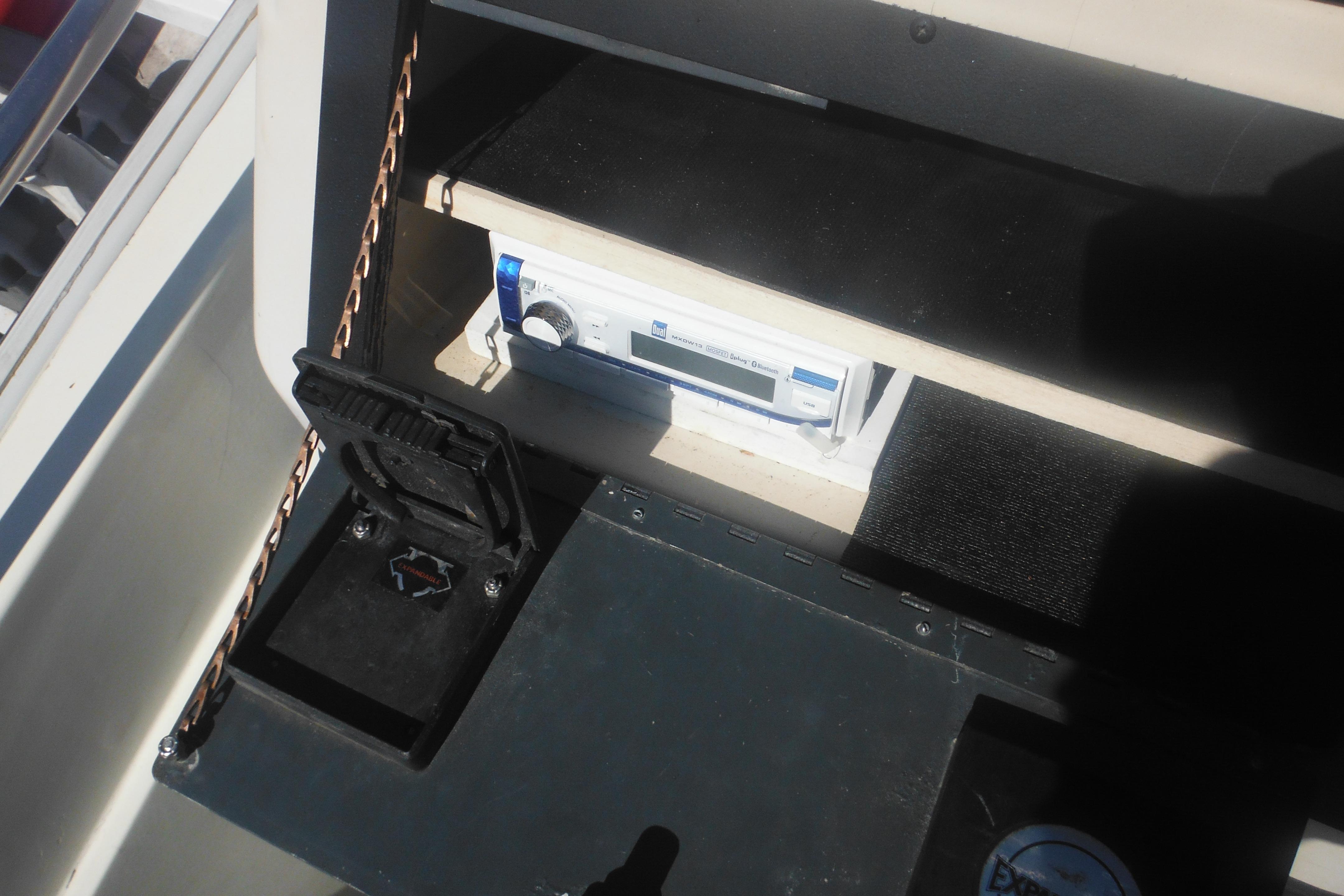 Interior view of a 1991 Boston Whaler 16 SL boat dashboard with stereo system.