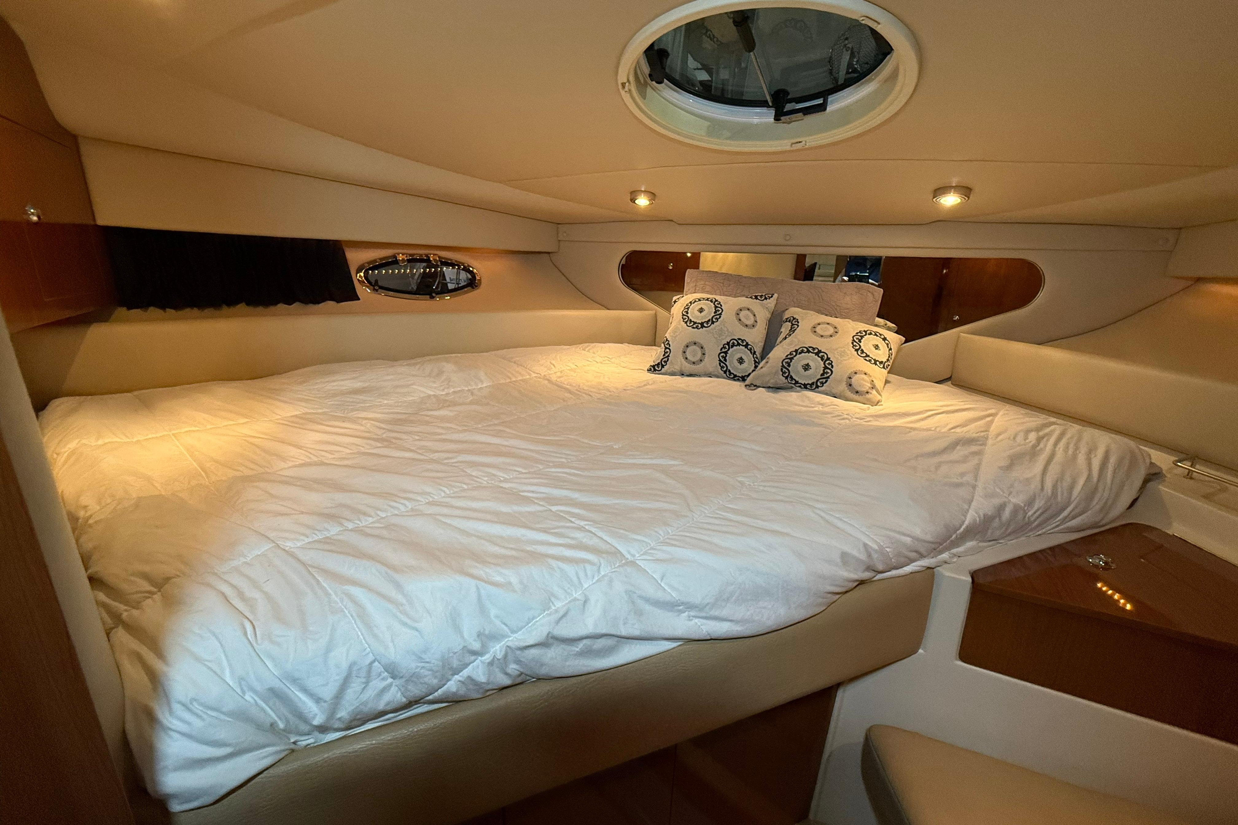Luxurious cabin interior of 2007 Regal Commodore 3760 IO yacht with cozy bedding.