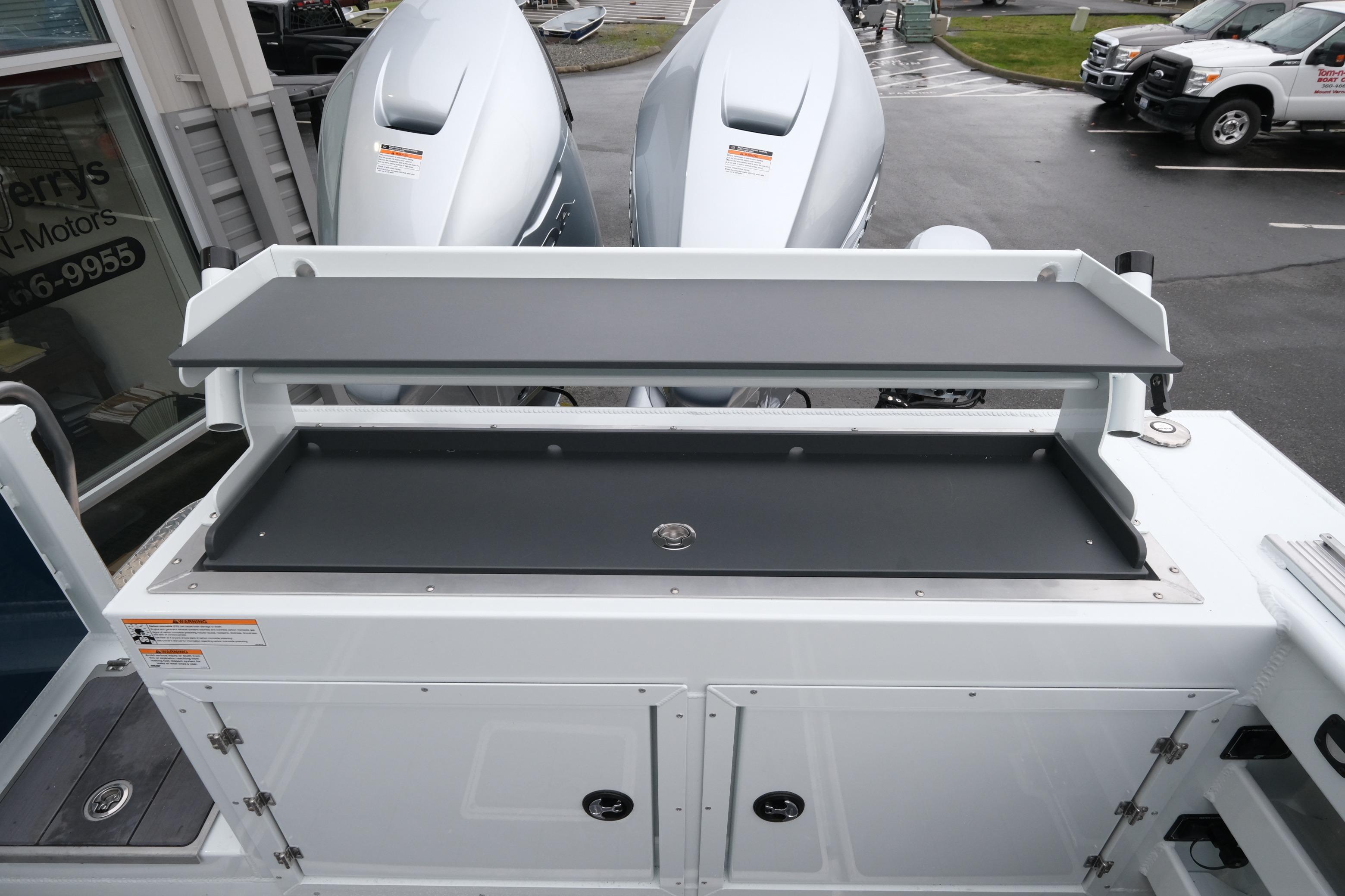 2026 Hewescraft 270 Pacific Explorer boat with dual outboard motors, featuring a spacious deck area.