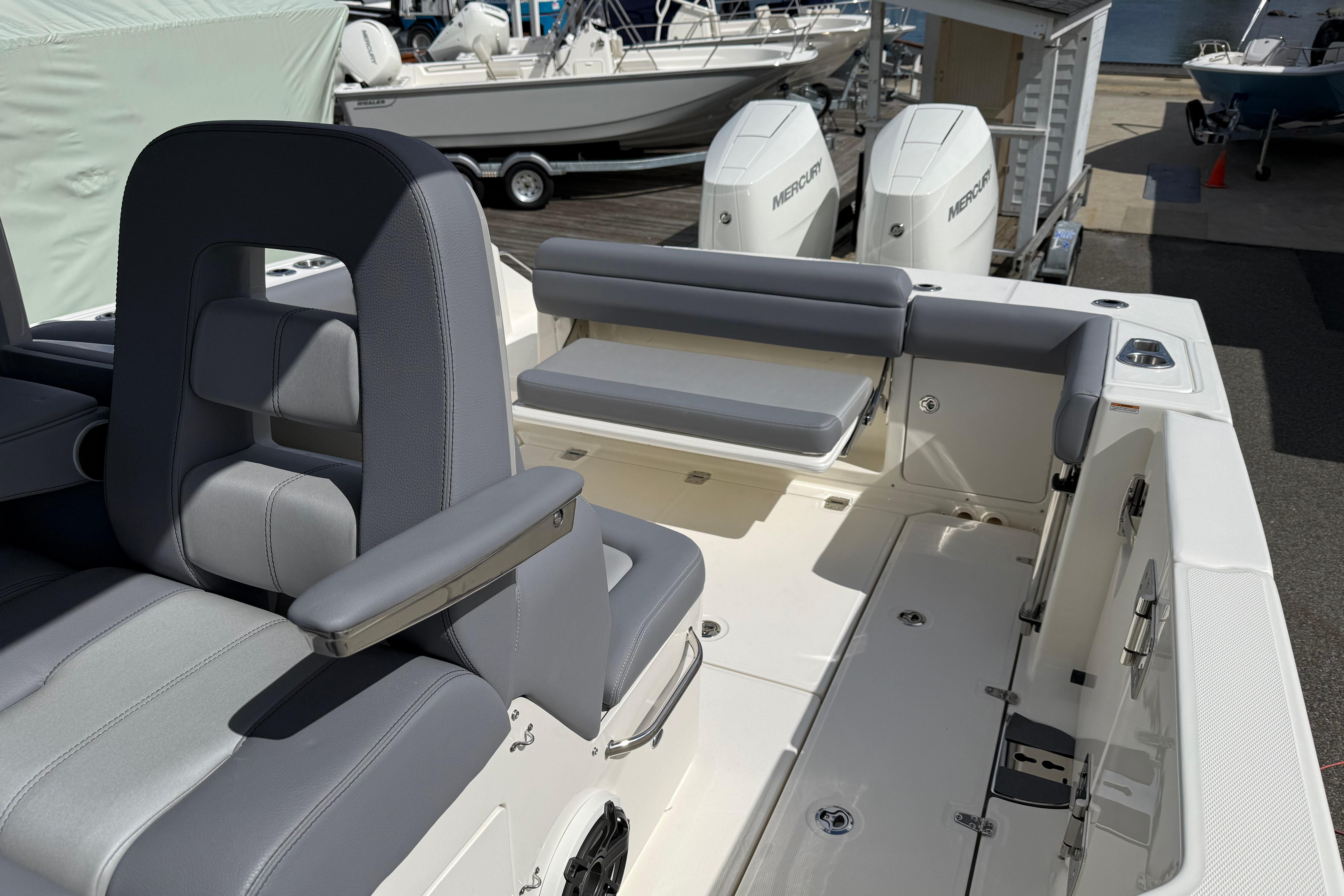 2026 Boston Whaler 330 Outrage boat interior with seating and dual Mercury engines.