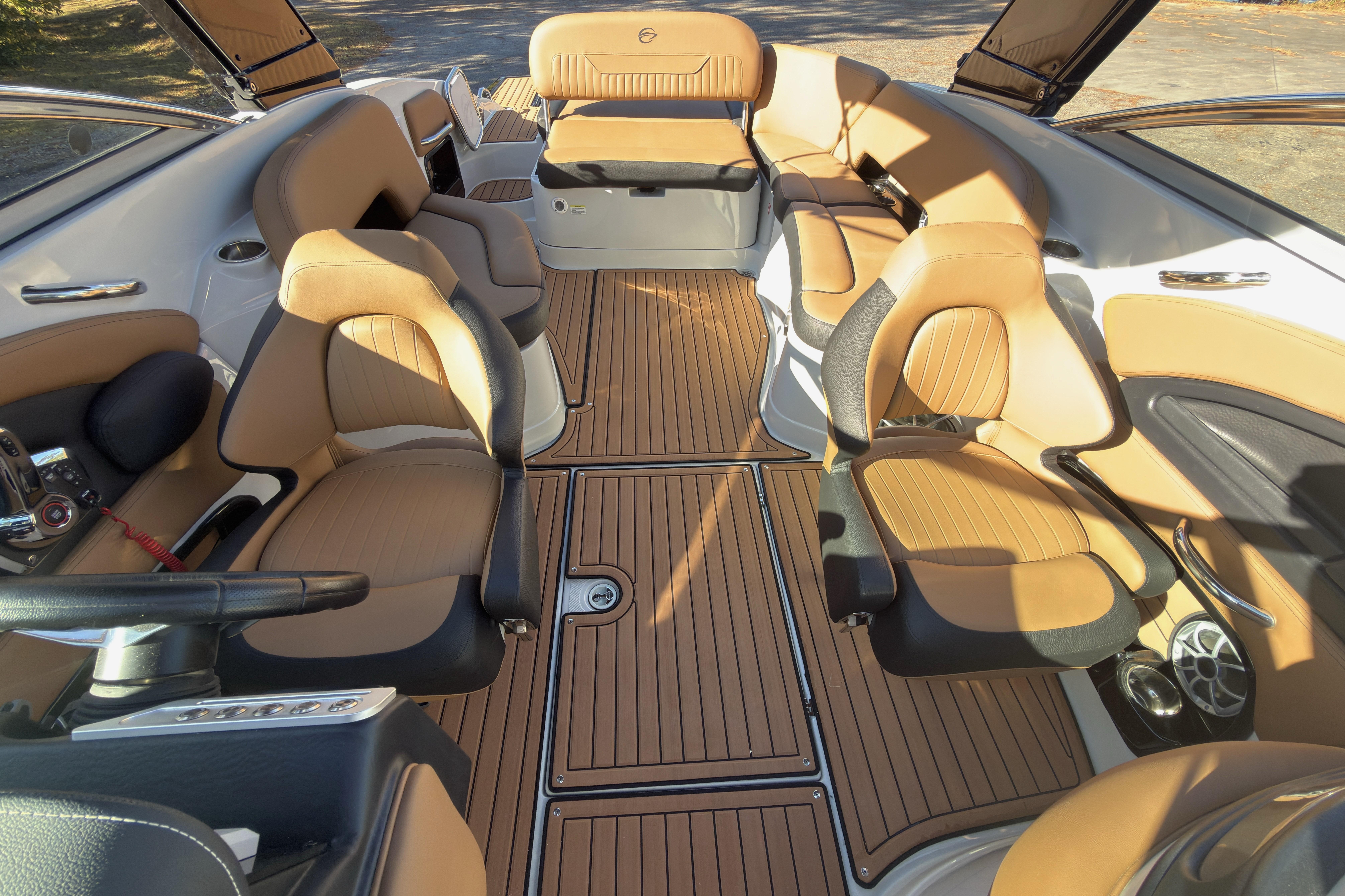 2026 Crownline 298 SS boat interior with tan leather seating and wood flooring.