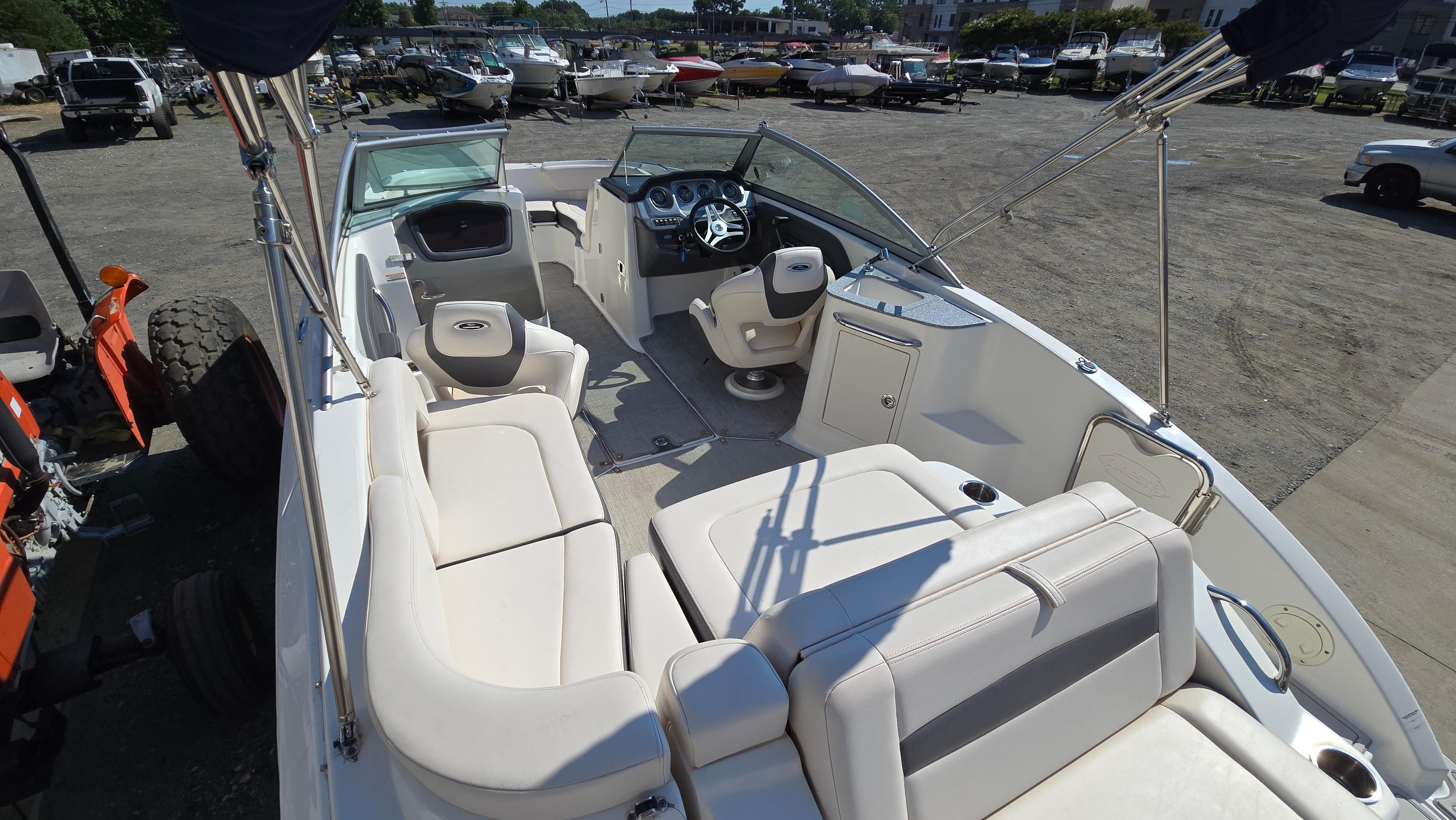 2018 Chaparral 224 Sunesta boat interior with seating and steering wheel, parked outdoors.