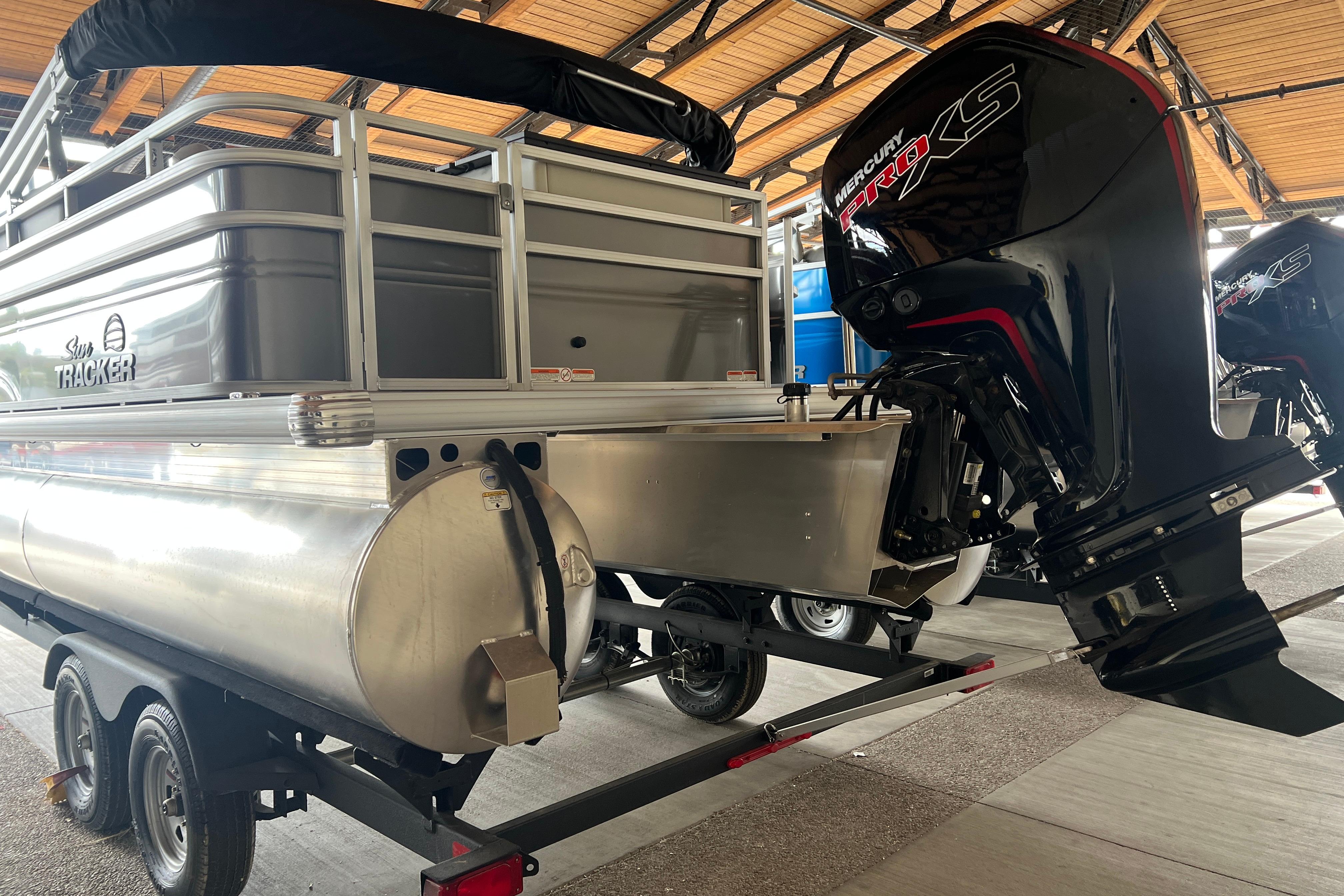 2026 Sun Tracker Fishin' Barge 20 DLX with Mercury outboard motor on trailer.