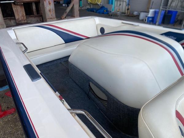 1998 Malibu Response boat interior with white and blue upholstery, featuring red accents.