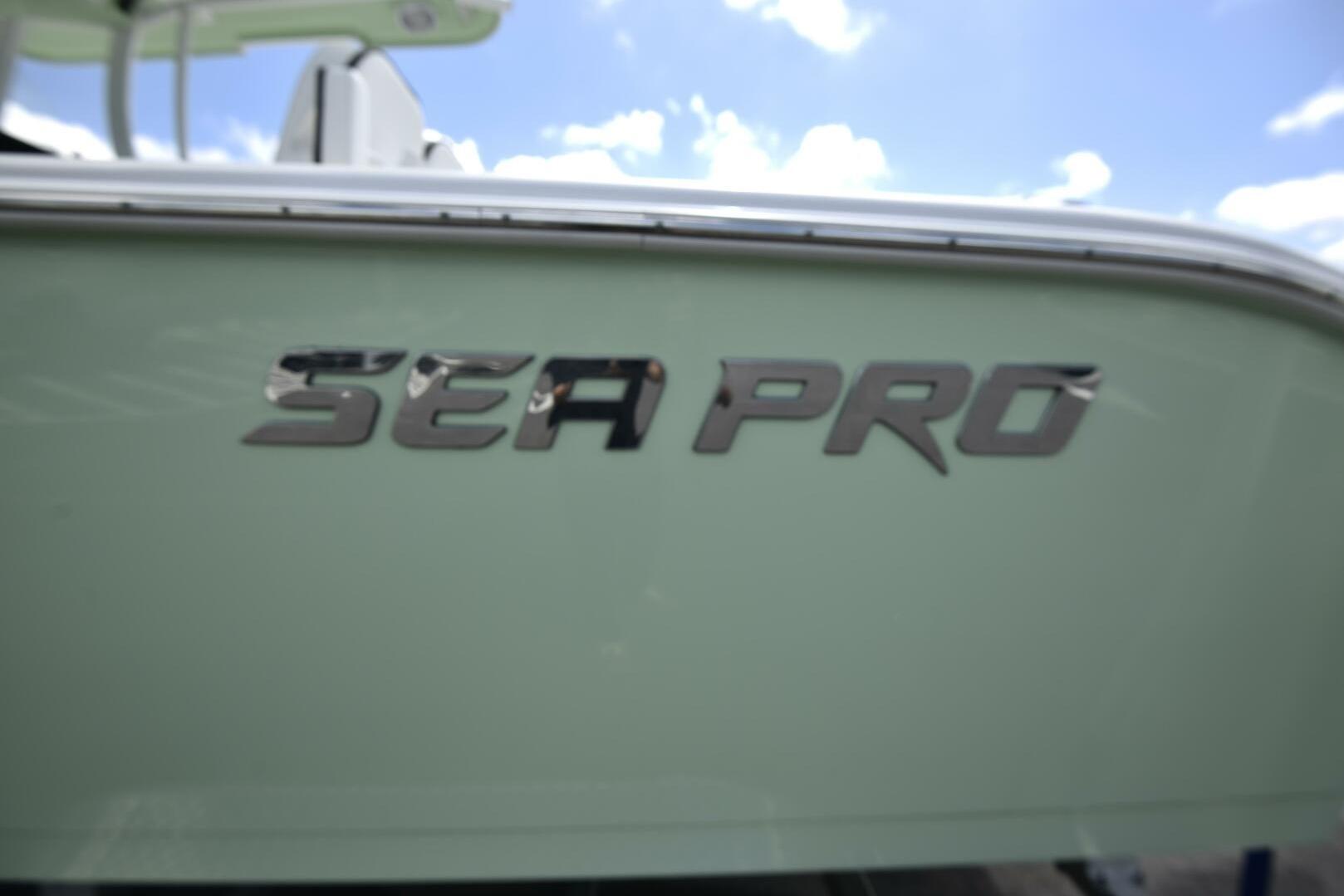 2023 Sea Pro 239 Deep V CC boat logo against a clear blue sky.
