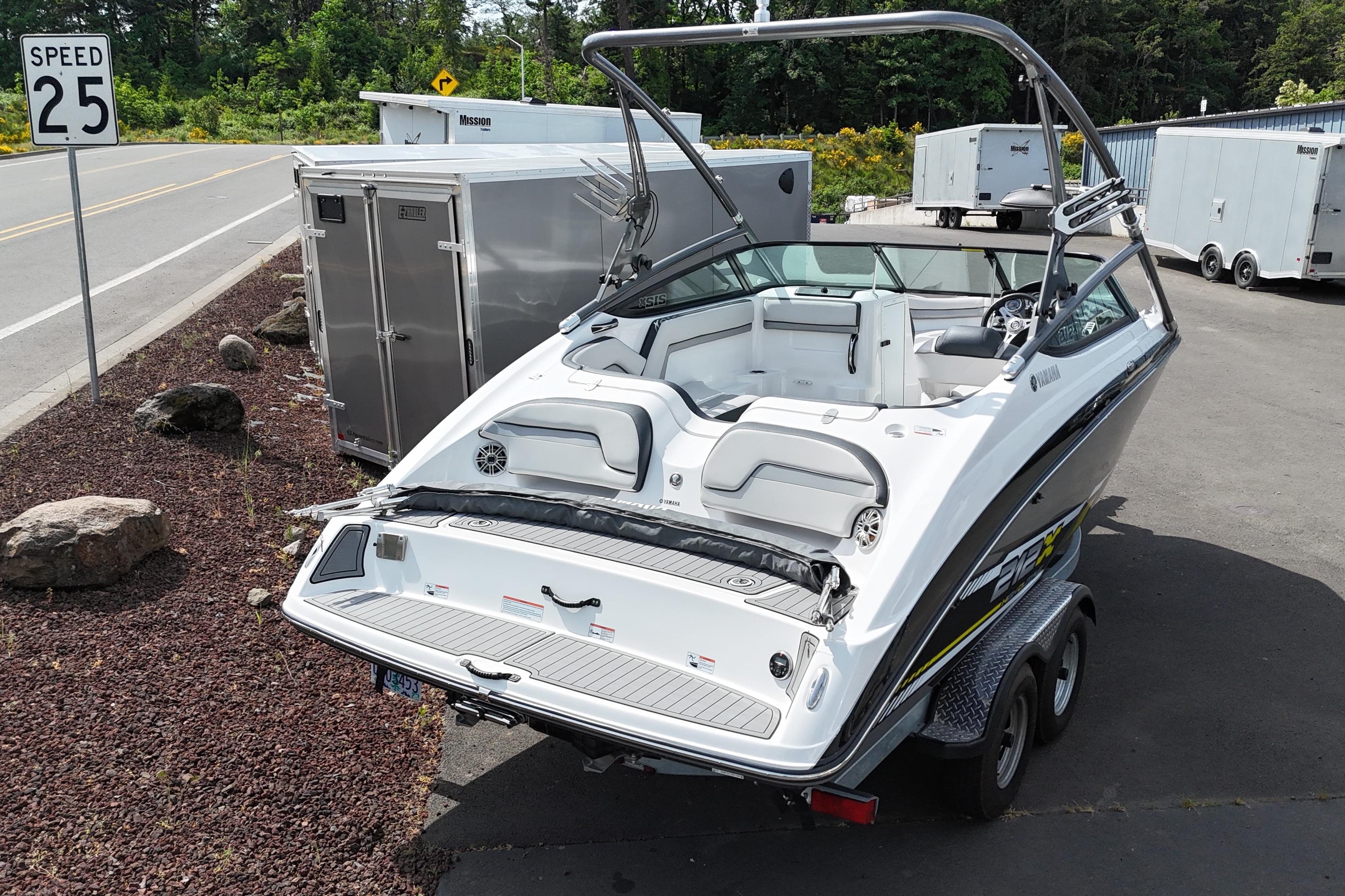 2016 Yamaha Boats 212X on trailer, parked near road with speed limit sign.