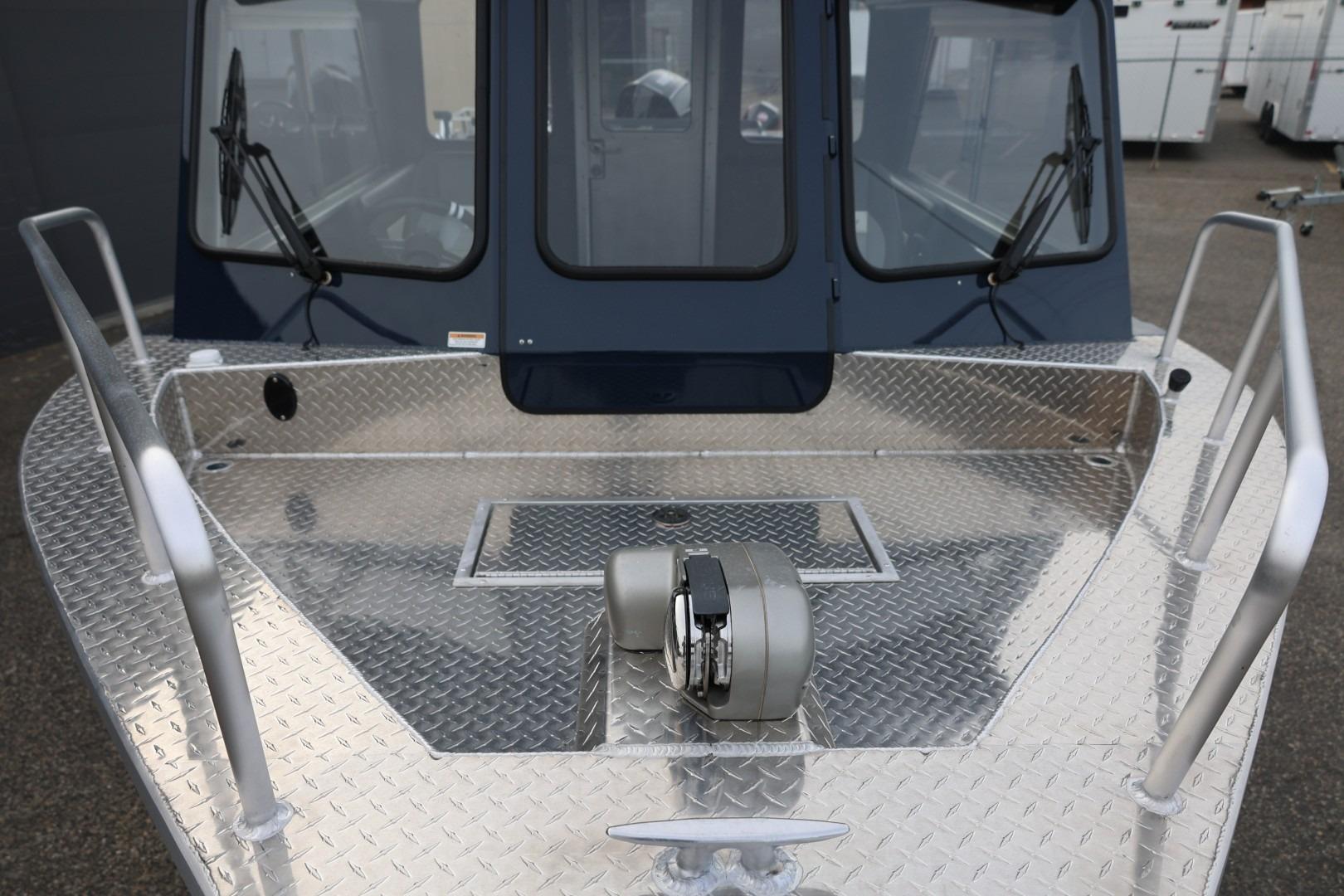 2026 Thunder Jet 24 Alexis Pro boat with diamond plate deck and windshield wipers.