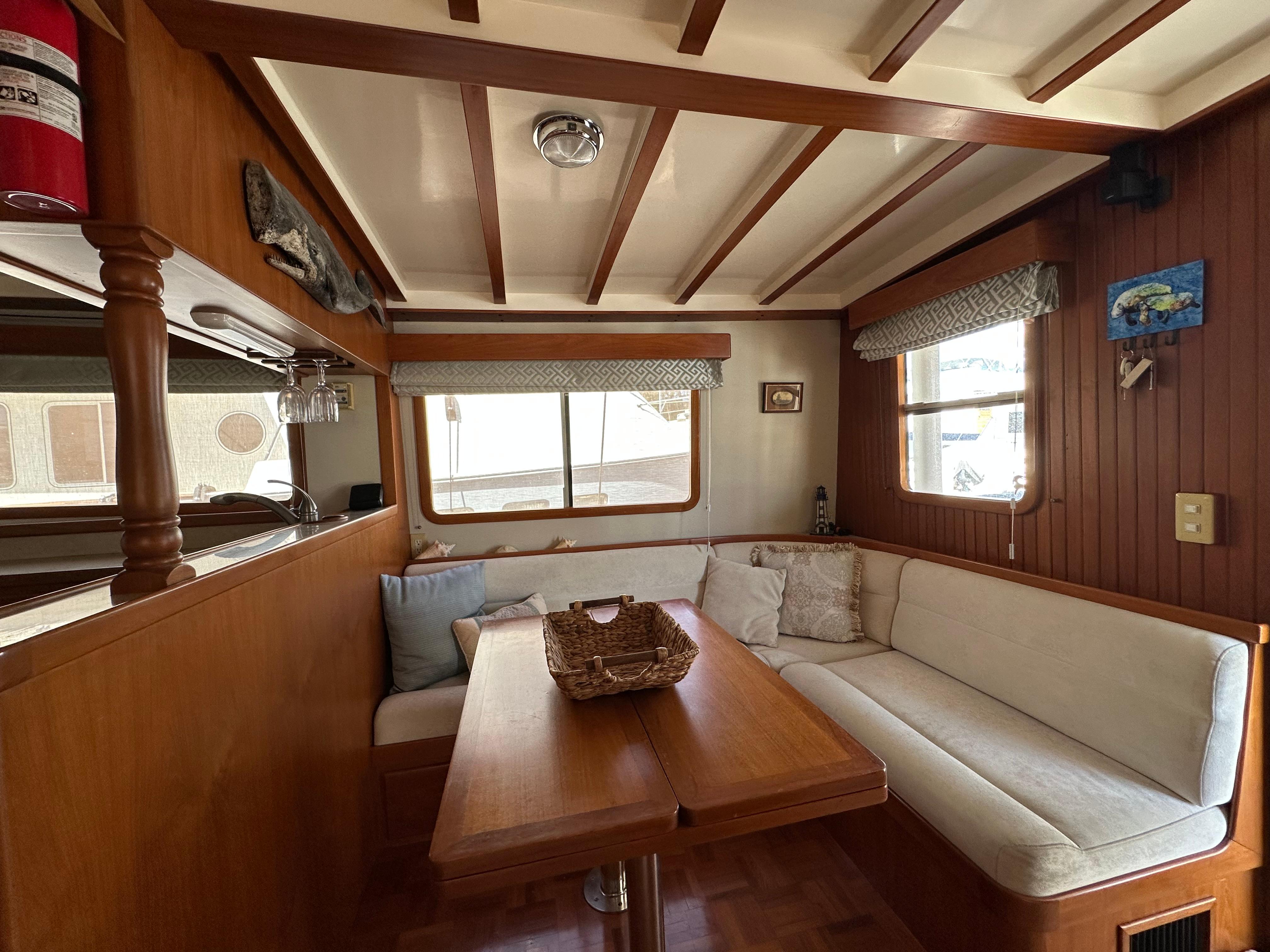 Cozy interior of 1997 Kadey-Krogen 48 Whaleback yacht with wood accents and seating area.