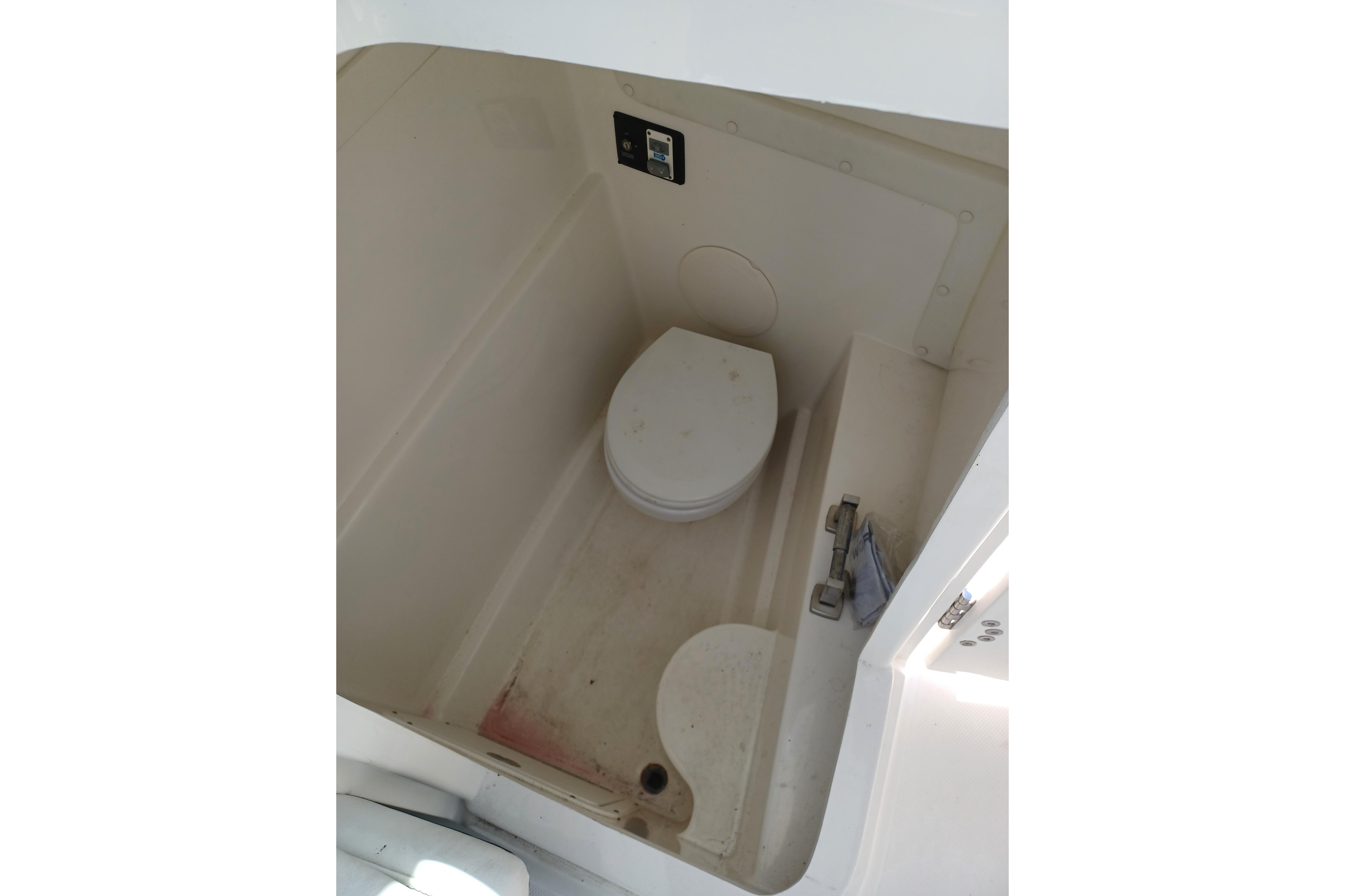 2020 World Cat 230 DC boat interior with compact marine toilet.