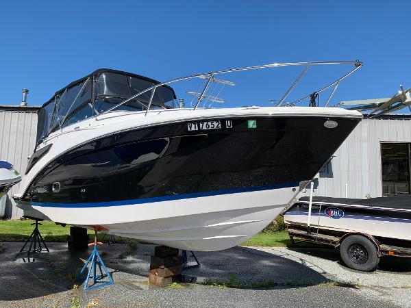 A 2017 Regal 26 Express boat is on a stand in front of a building.