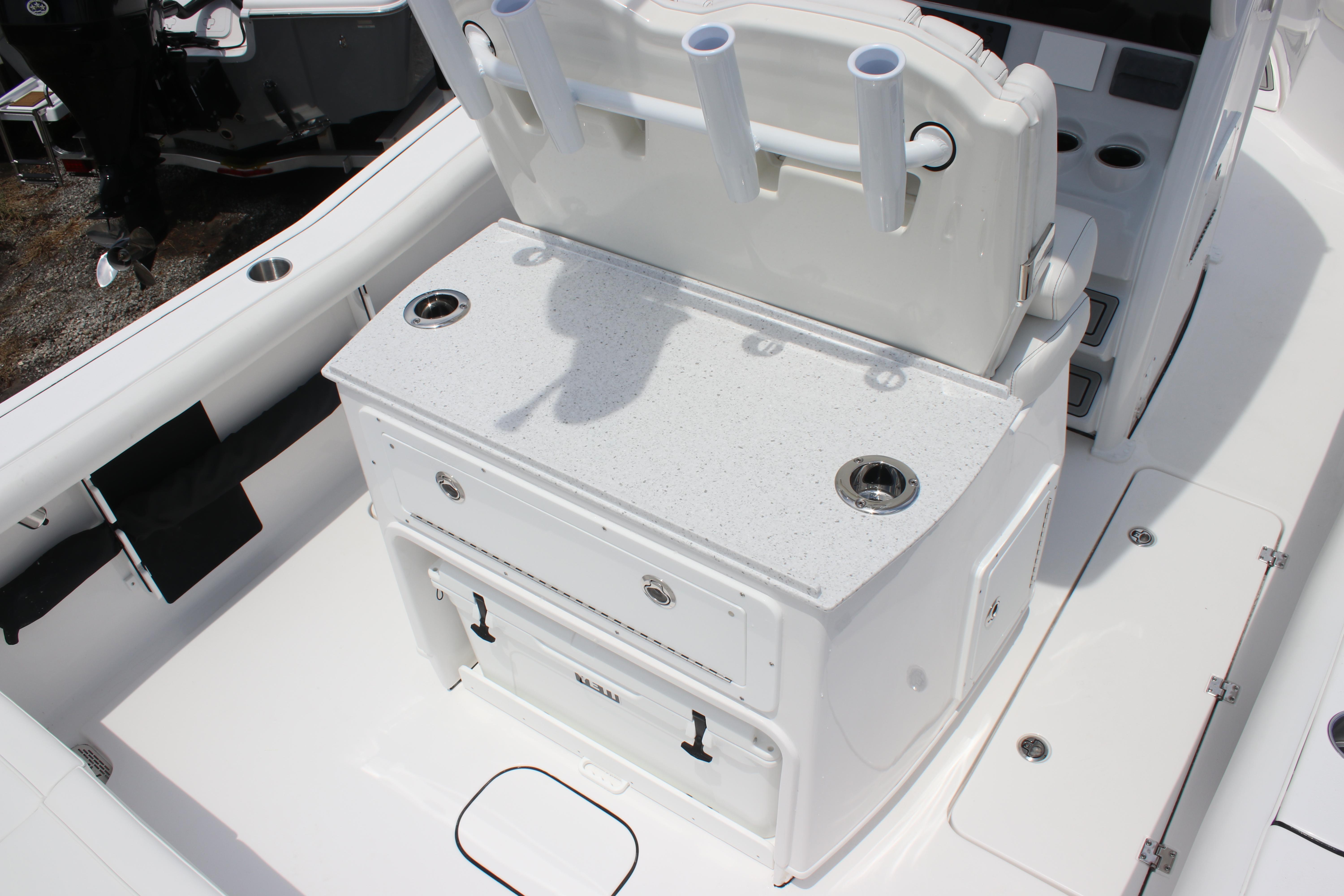 2026 Tidewater 272 LXF boat interior with fishing rod holders and storage compartments.