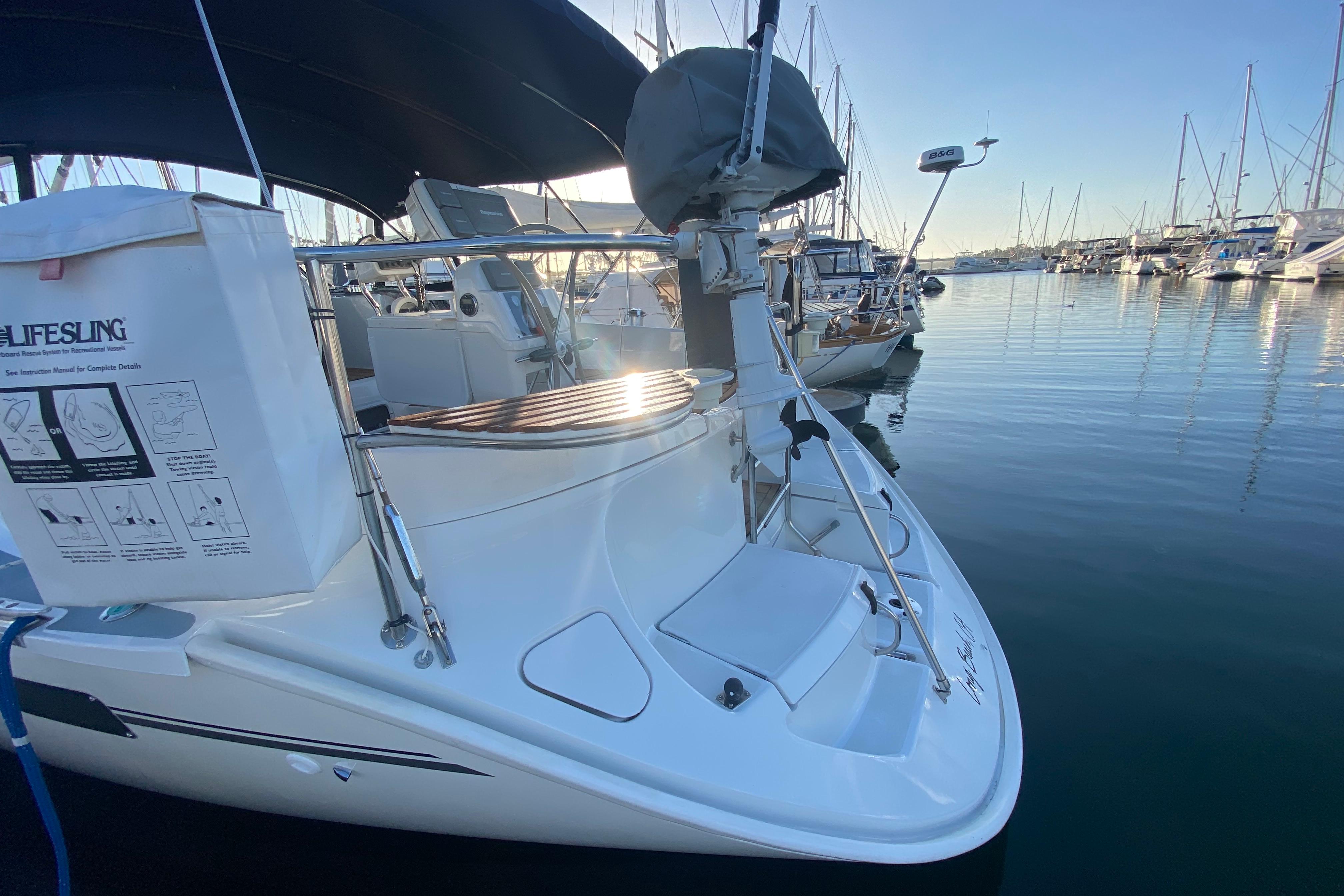 Hunter Legend 40.5 sailboat, 1997 model, docked in a marina with clear skies.