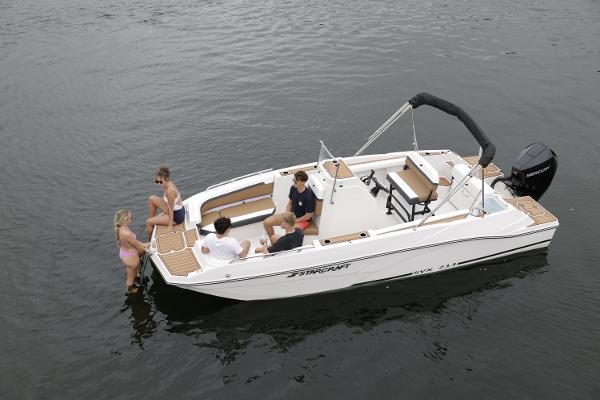 2025 Starcraft SVX 211 OB CC boat with people enjoying water activities.