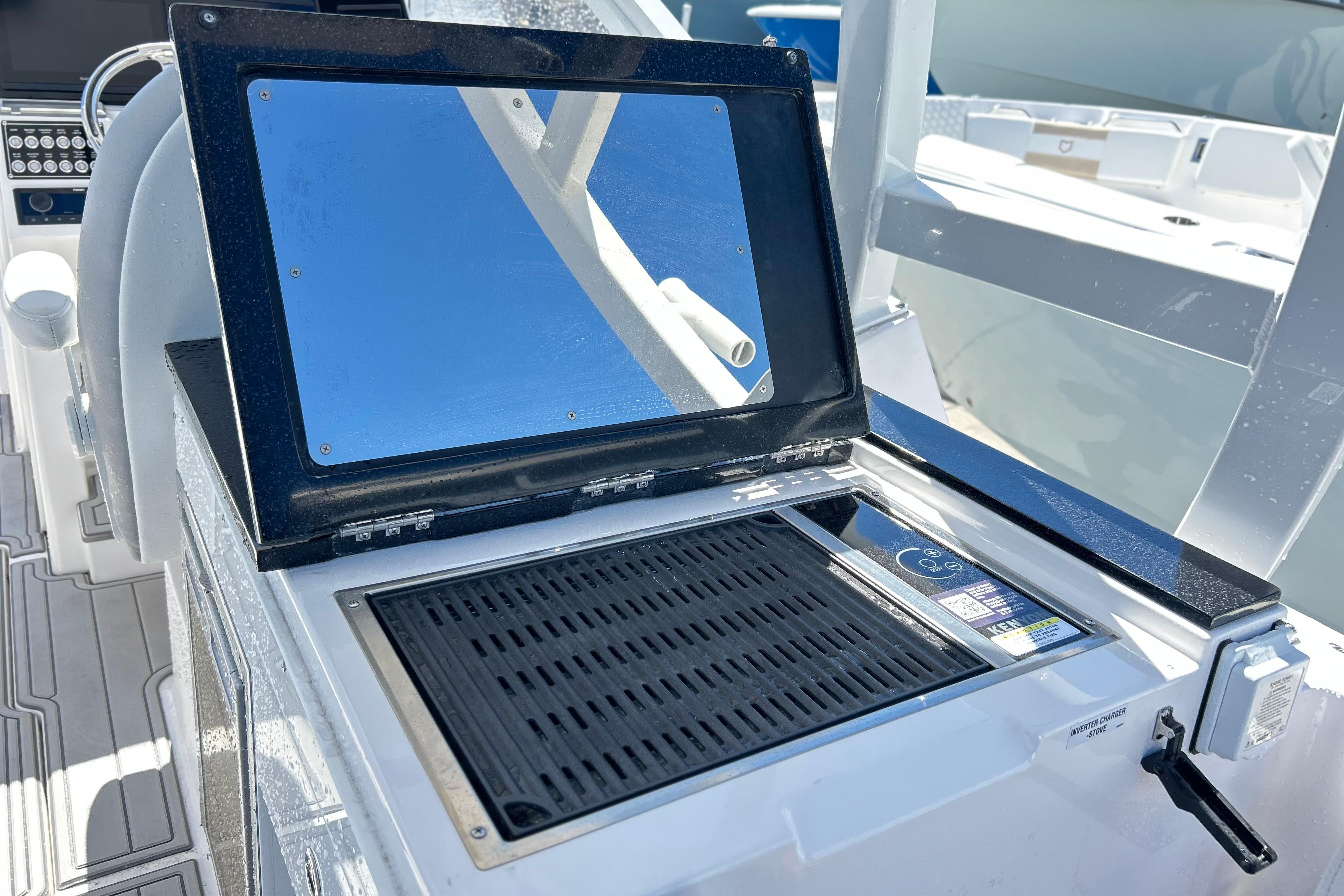 2025 Sea Fox 288 Traveler boat grill and prep station with reflective cover.