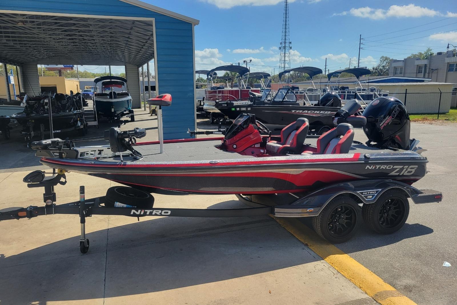 2026 Nitro Z18 boat with trailer, parked outdoors at a dealership.