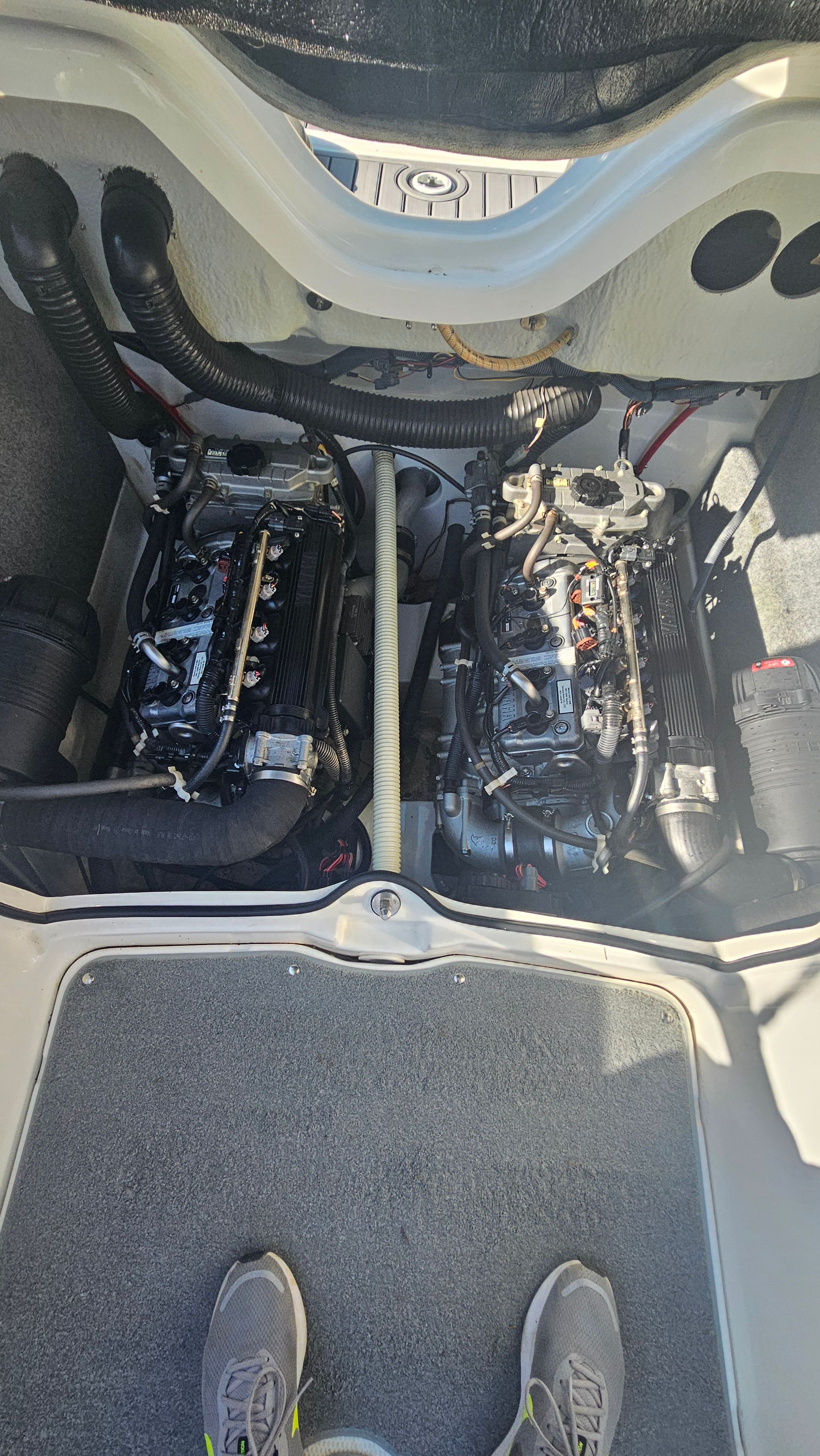View of the engine compartment of a 2010 Yamaha AR210 boat with two engines.
