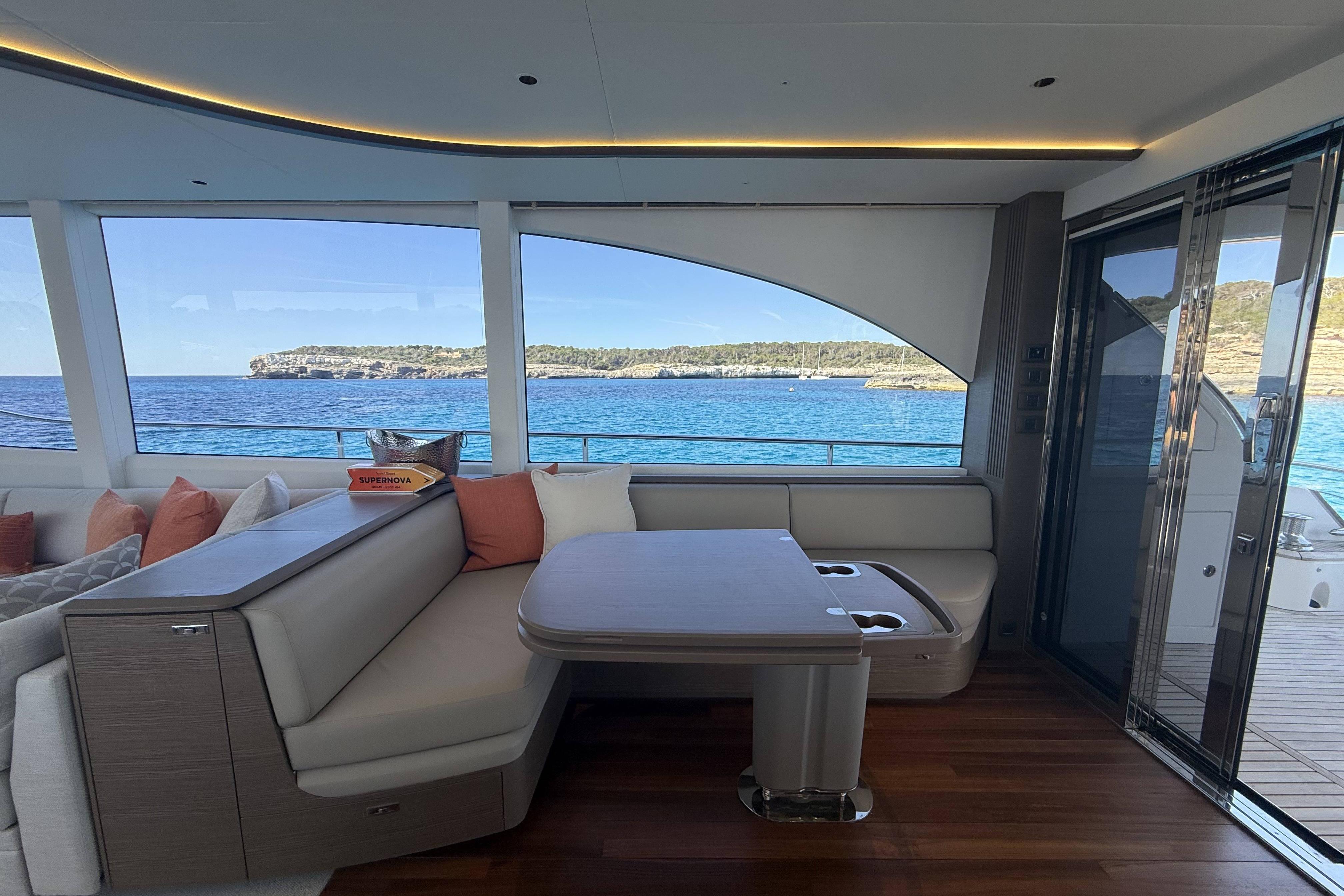 Luxurious interior of 2025 Princess Y72 yacht with ocean view and elegant seating area.