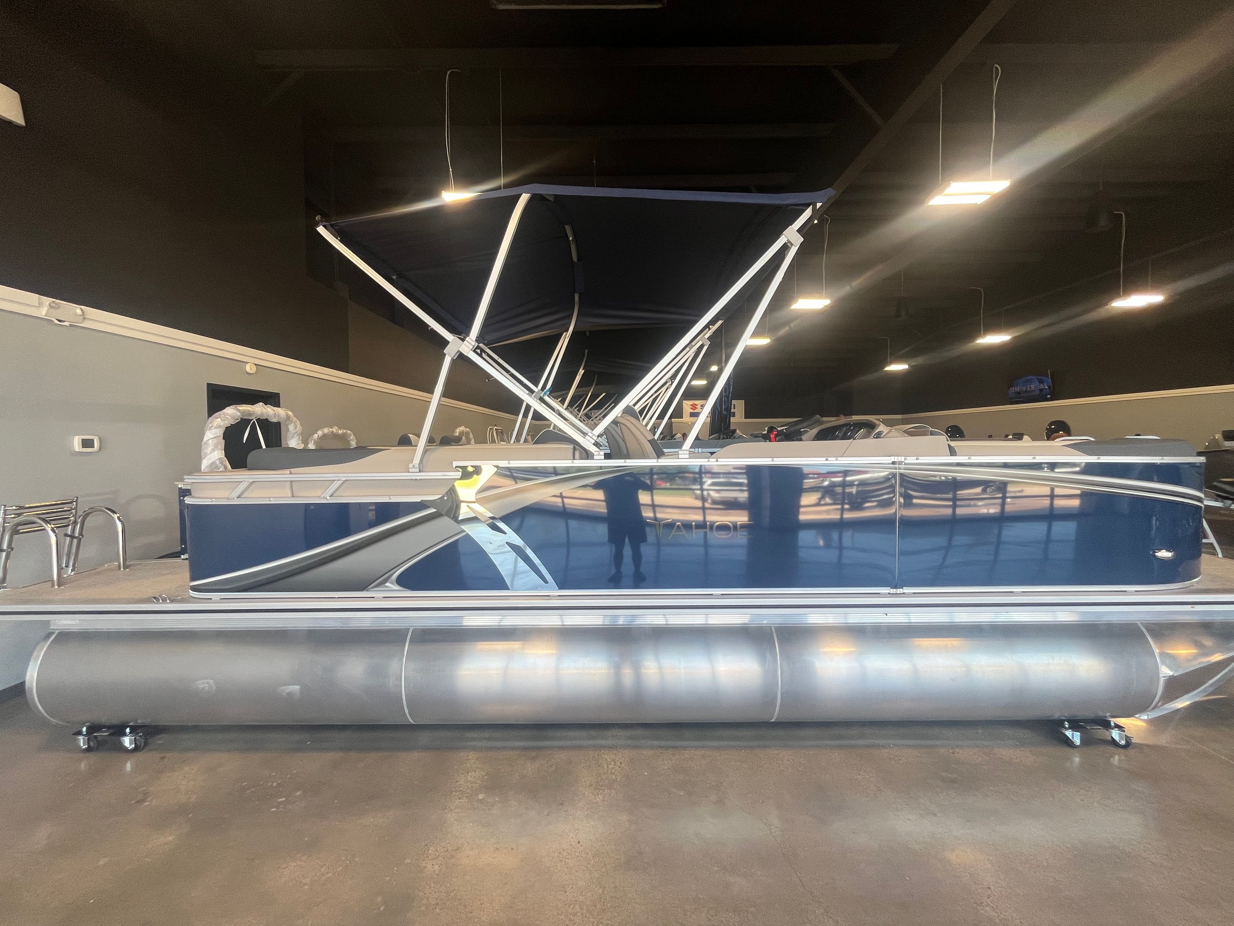 2025 Tahoe LTZ QL pontoon boat in a showroom.