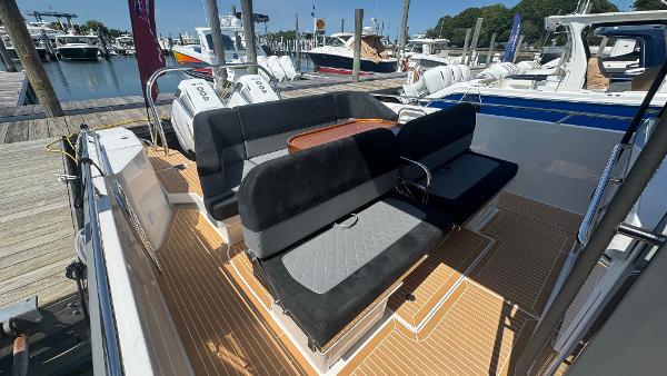 Luxurious 2025 Nimbus T11 boat with sleek seating and powerful engines at a marina.