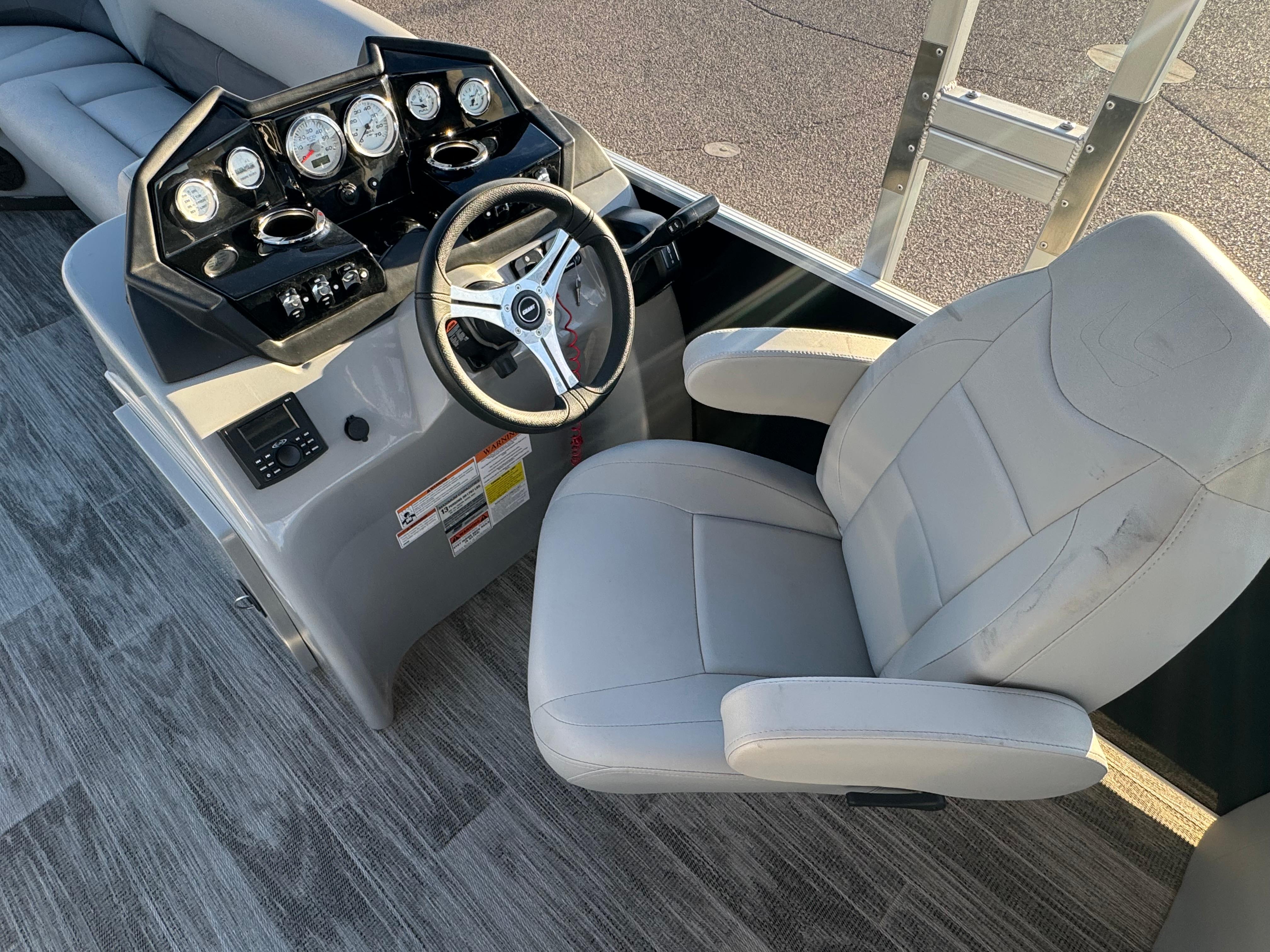 2024 Landau Island Breeze 252 boat helm with steering wheel and gauges.