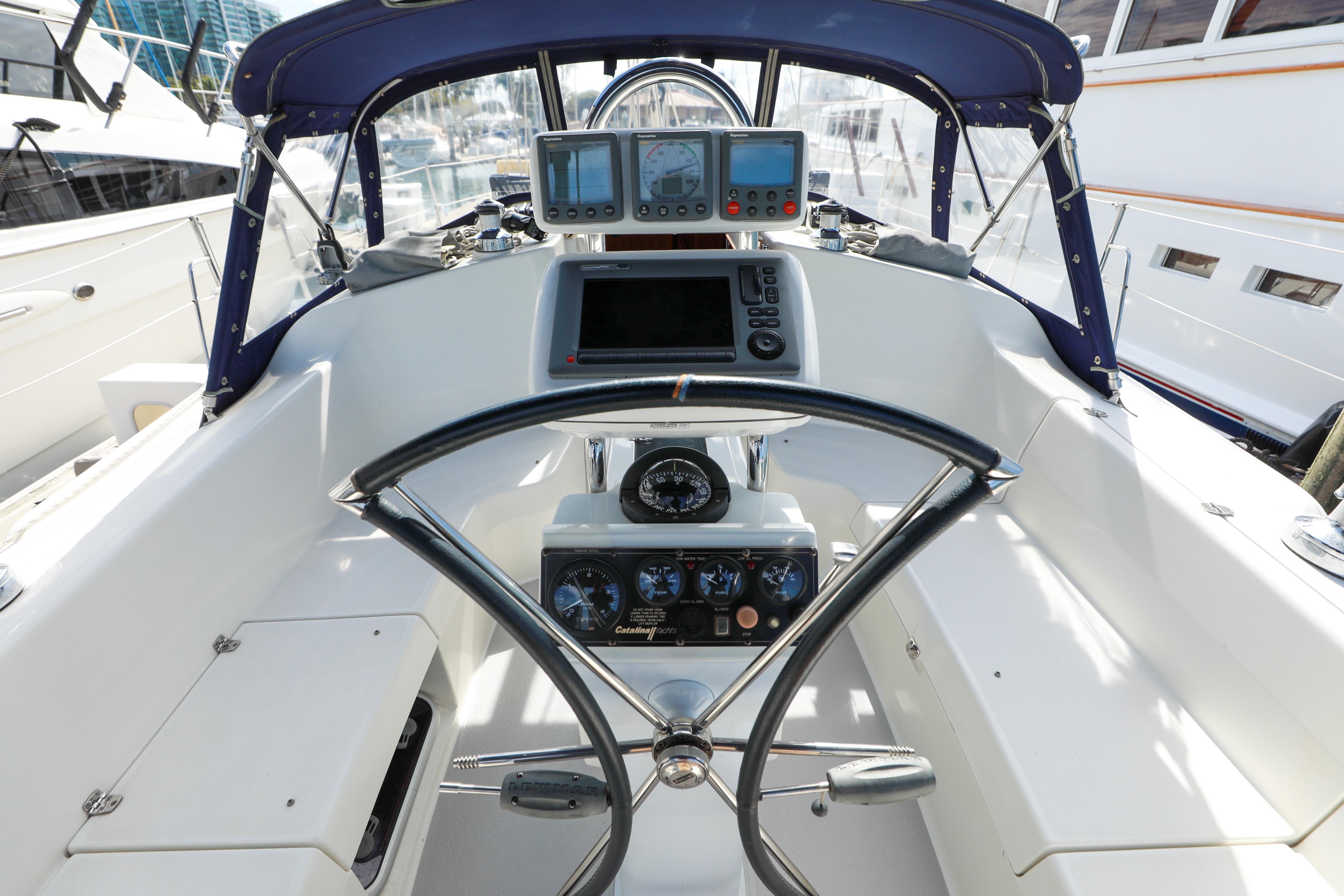 Cockpit of a 2010 Catalina 375 sailboat with navigation instruments and steering wheel.