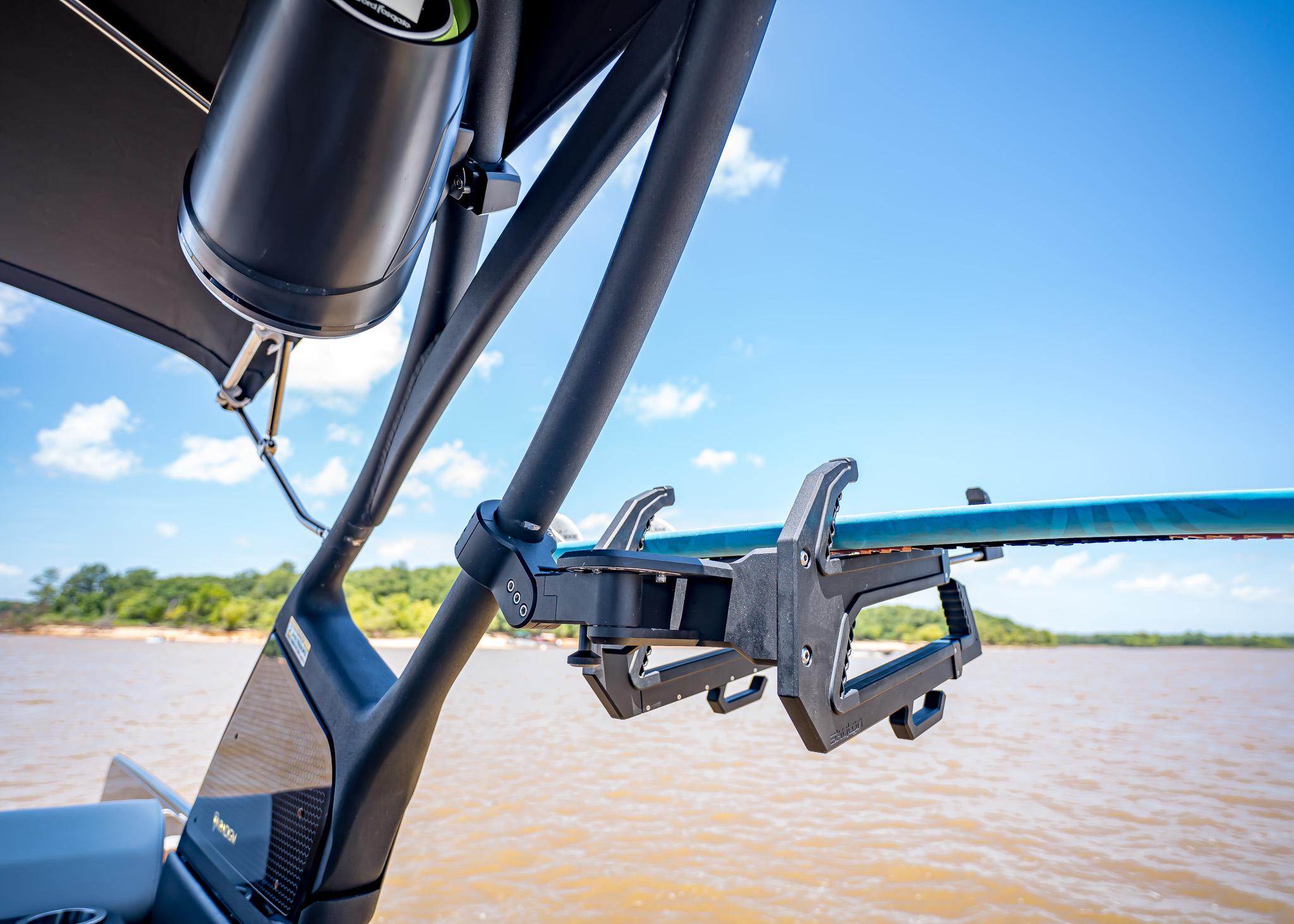 Wakeboard rack on a 2025 Paradigm 236 boat, with scenic lake view.