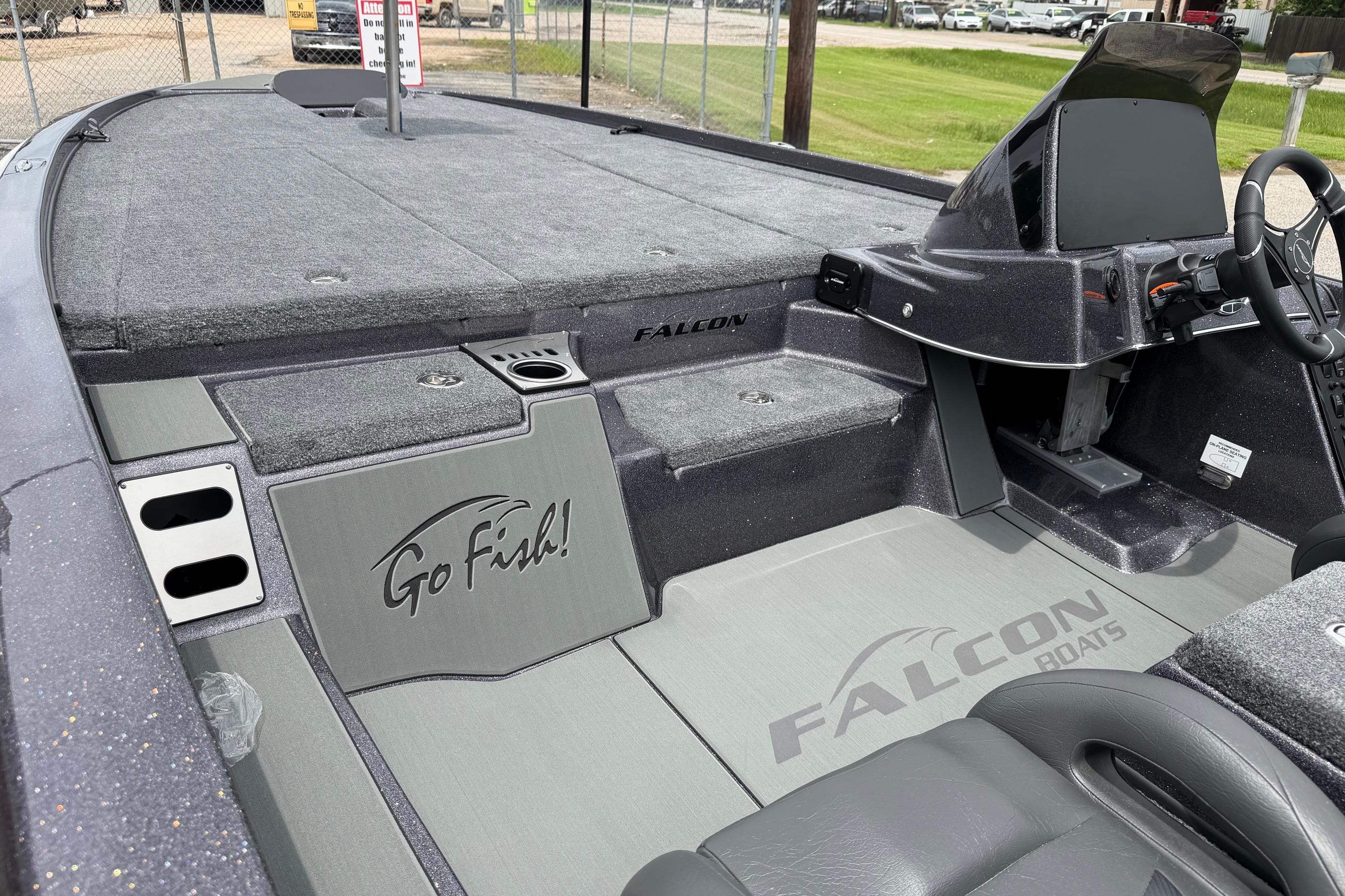 2027 Falcon Boats F215 interior with "Go Fish!" logo, steering console, and seating area.