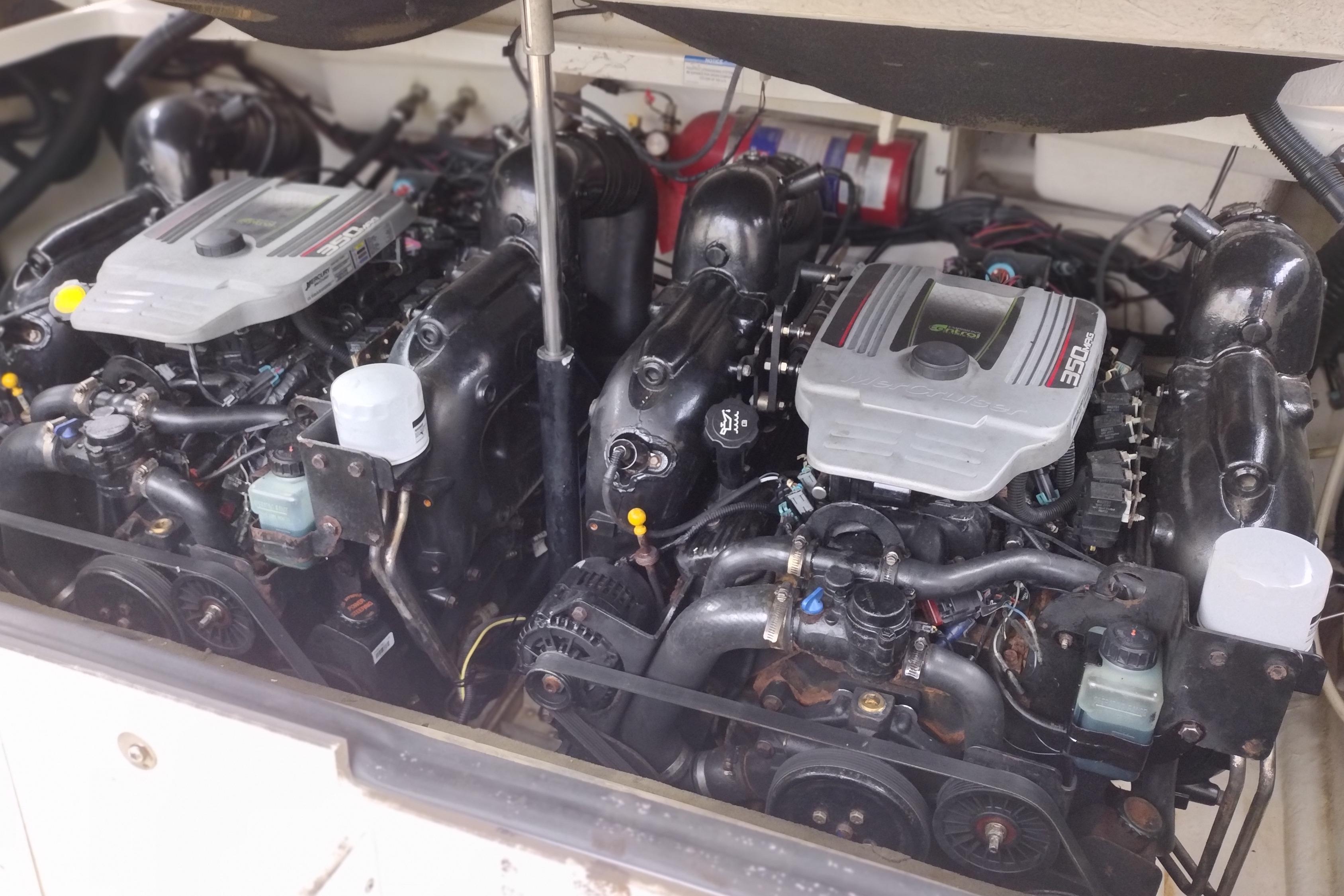 Twin engines of a 2013 Sea Ray 300 SLX boat, showcasing detailed mechanical components.
