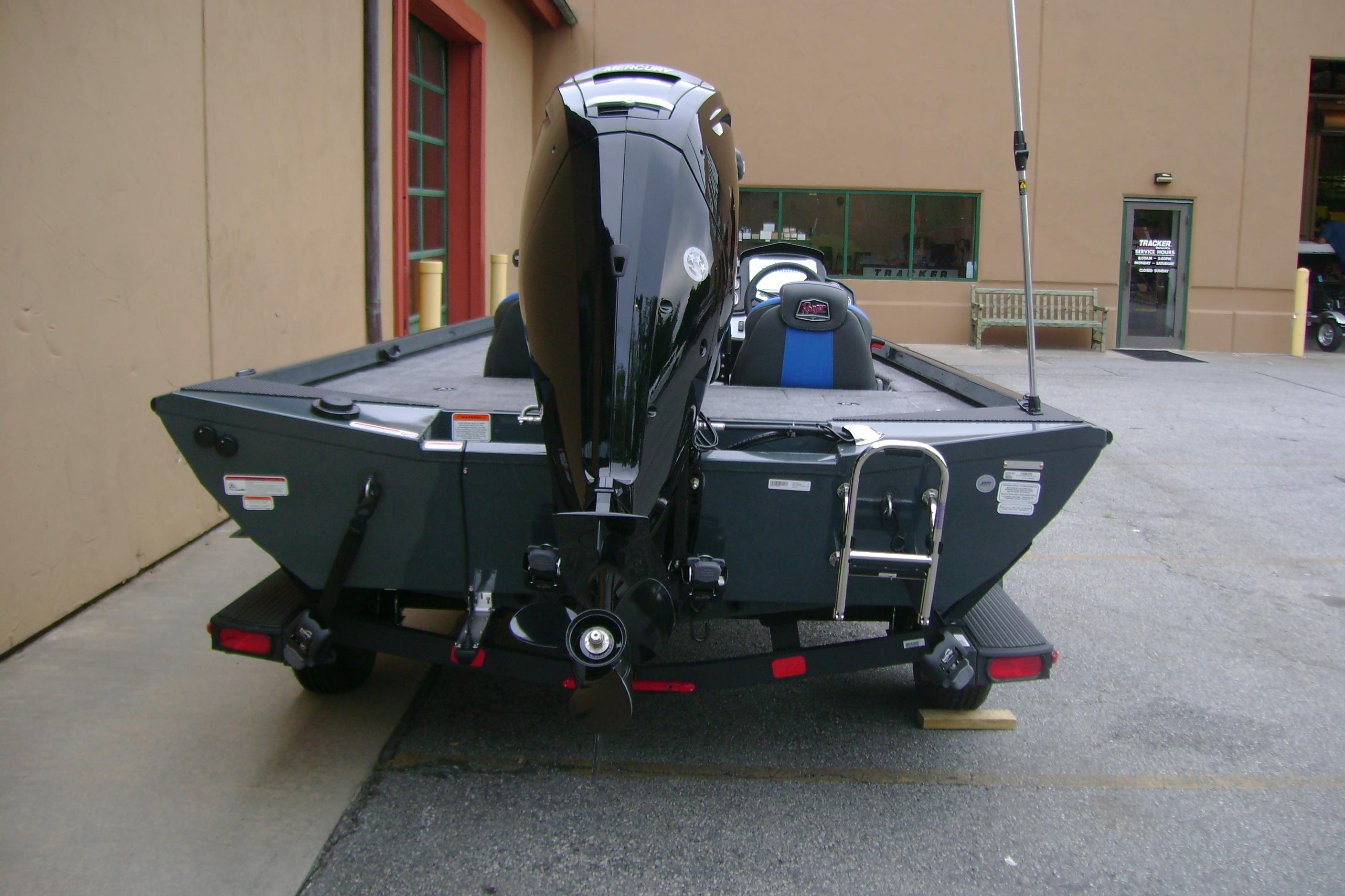 2026 Ranger RT178C boat with motor, parked outside a building.
