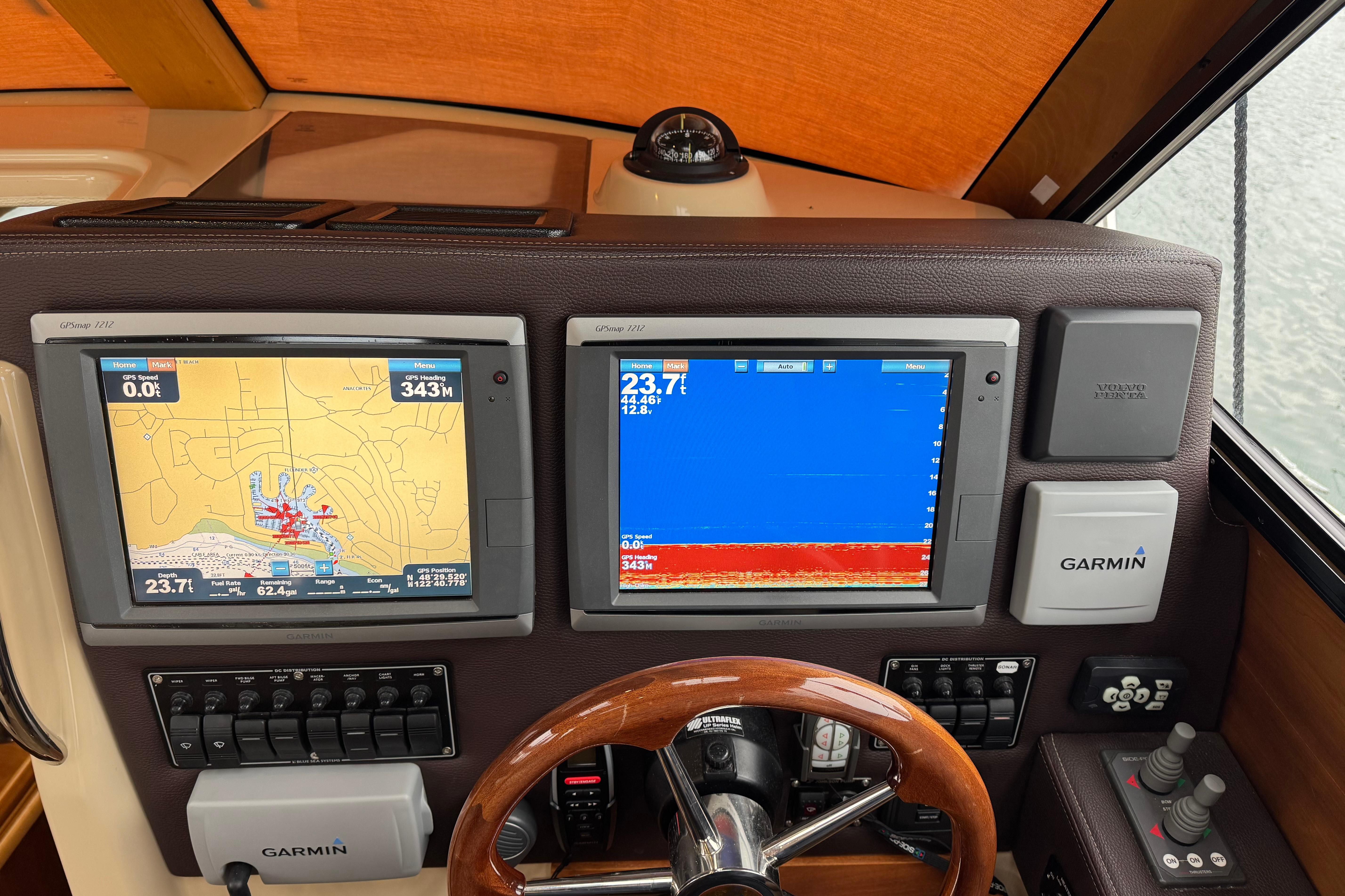 Dashboard of a 2014 Cutwater 28 boat with Garmin navigation displays.