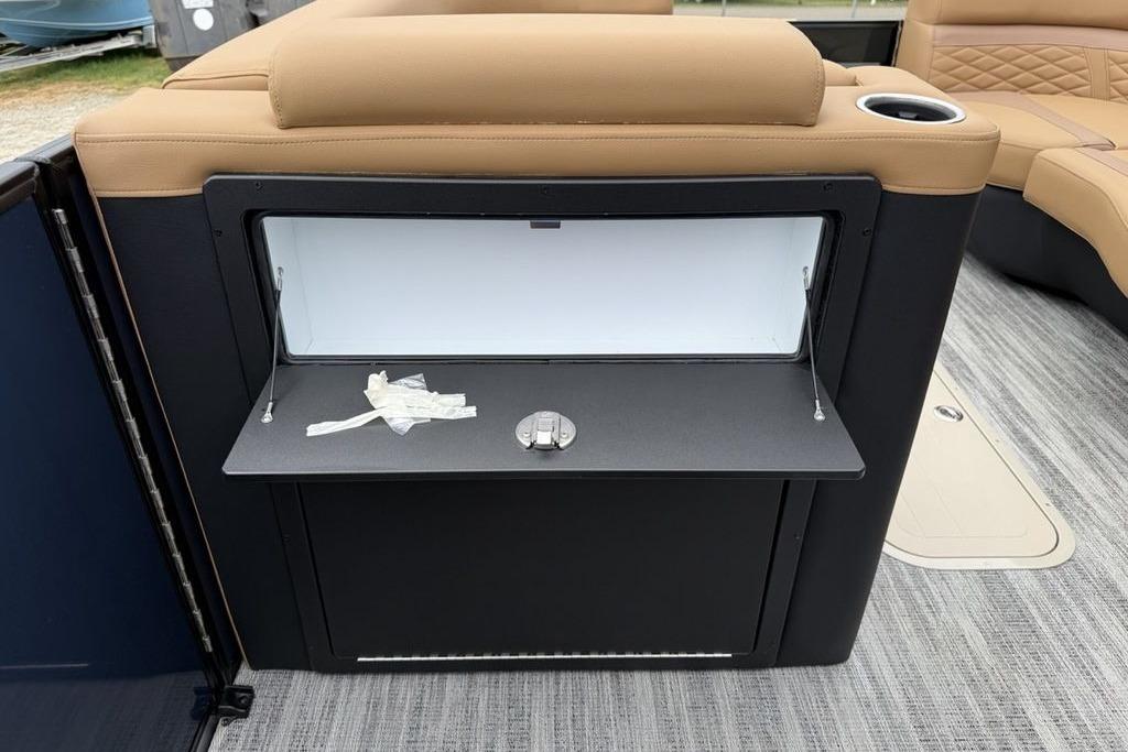 Interior view of 2026 Godfrey Monaco 235 SFLC iMPACT boat with storage compartment.