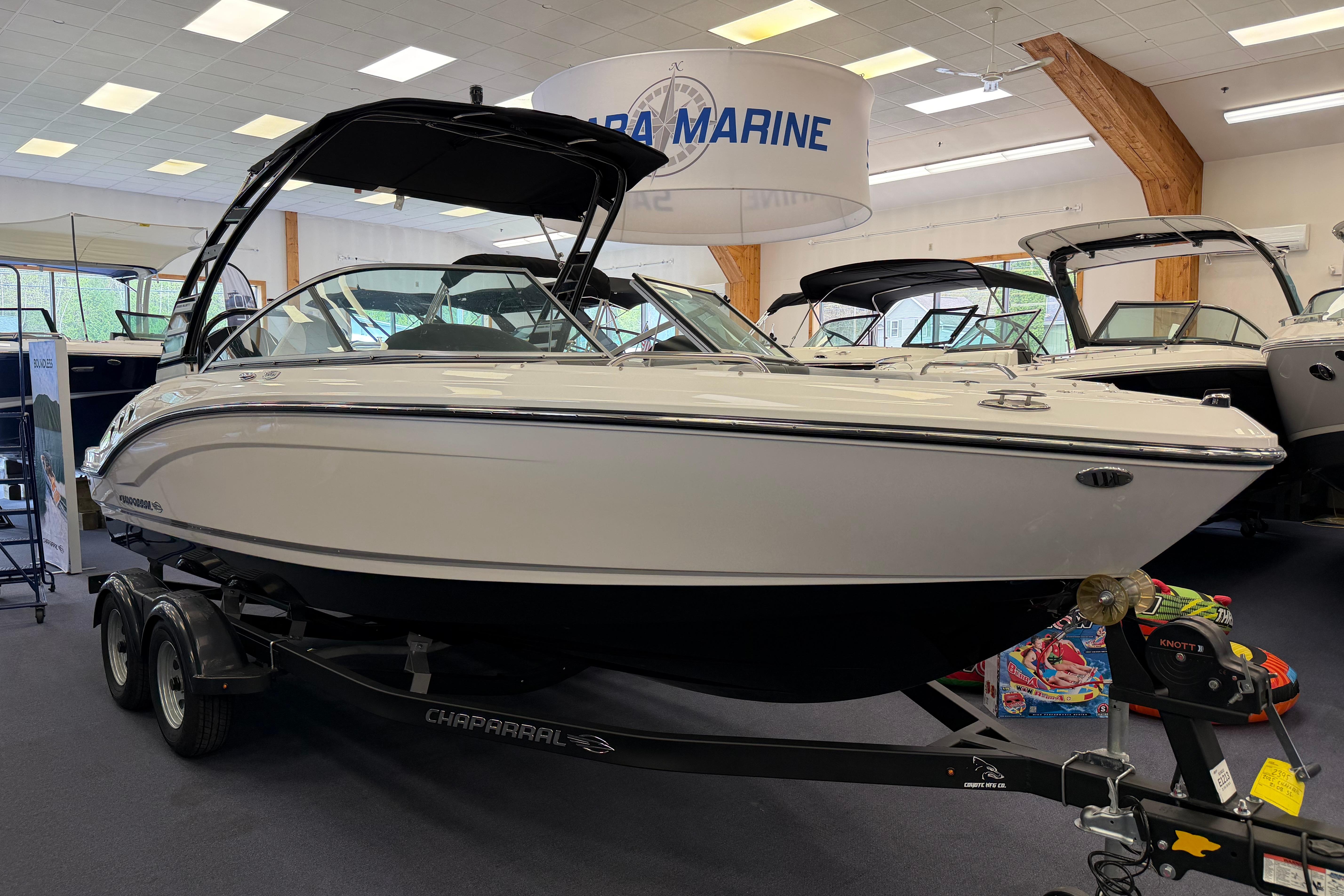 2025 Chaparral 21 SSi OB boat displayed in a showroom.