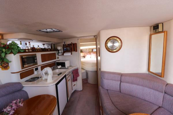 Interior of 1992 Sea Ray 350 Express Bridge yacht with kitchen and seating area.