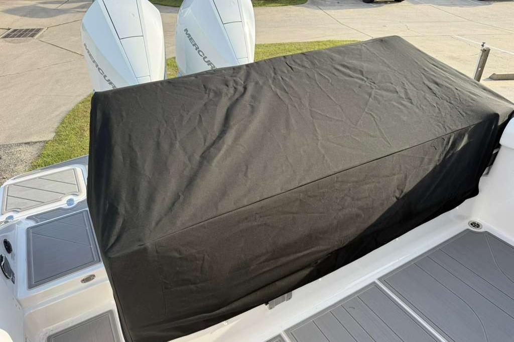 2026 Monterey Elite 30 OB boat with covered seating area and dual Mercury outboard engines.
