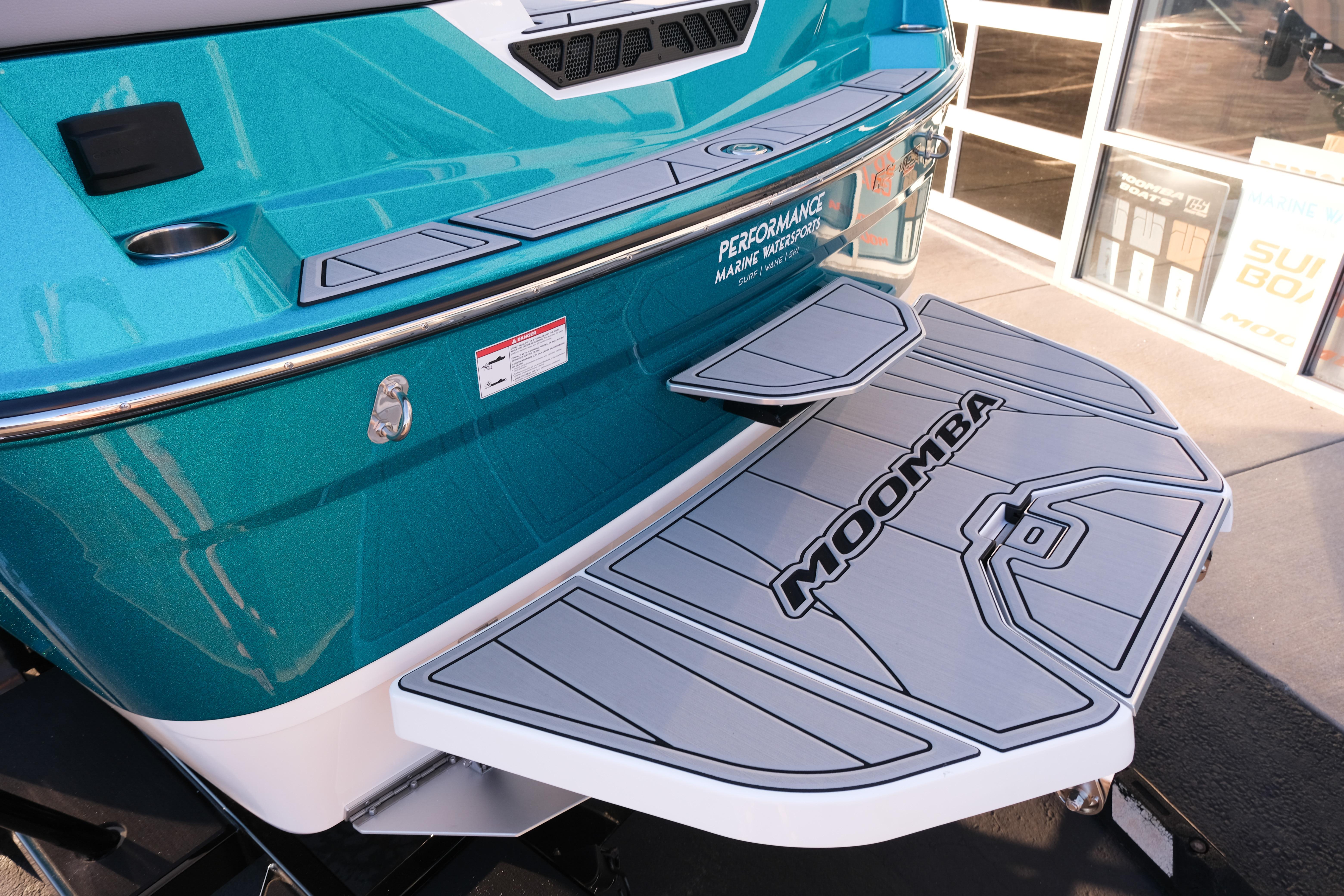 2026 Moomba Max boat with teal exterior and branded swim platform.