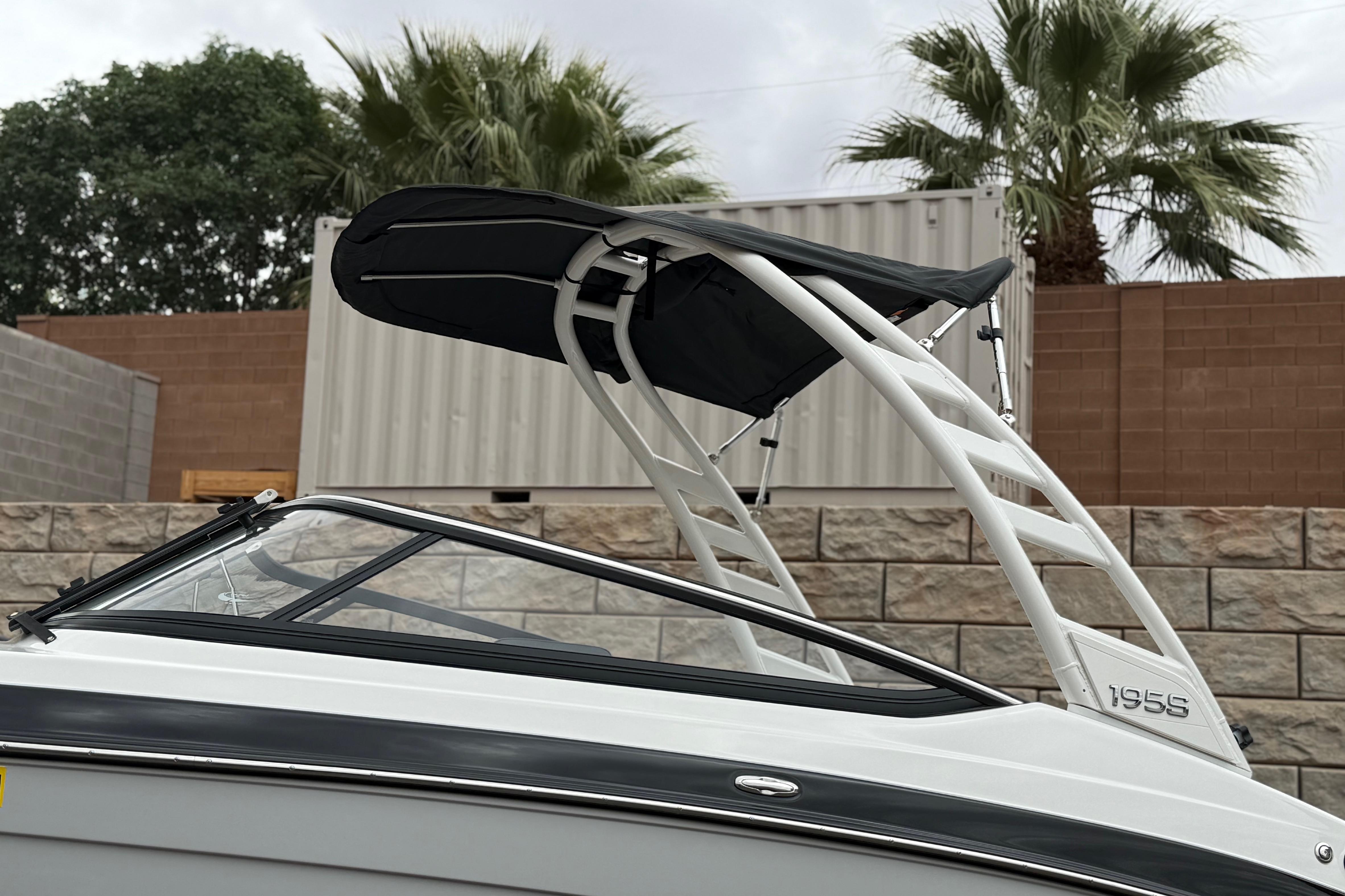 2025 Yamaha Boats 195S with sleek design and canopy, set against a tropical backdrop.